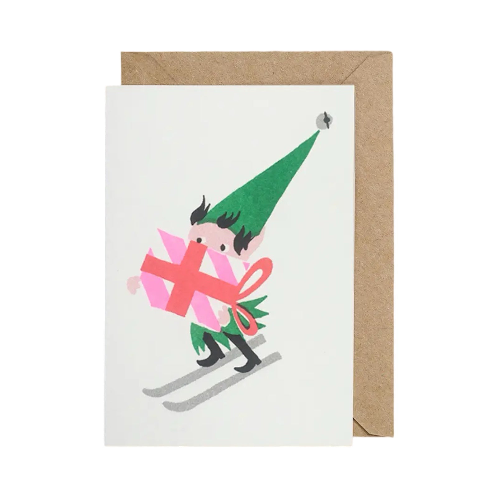Christmas card featuring an elf skiing holding a giant Christmas present