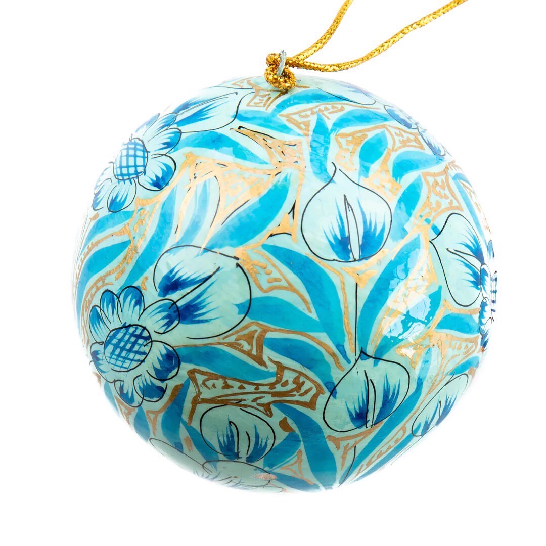 A round papier mache bauble in gold with a sky blue and turquoise floral design.