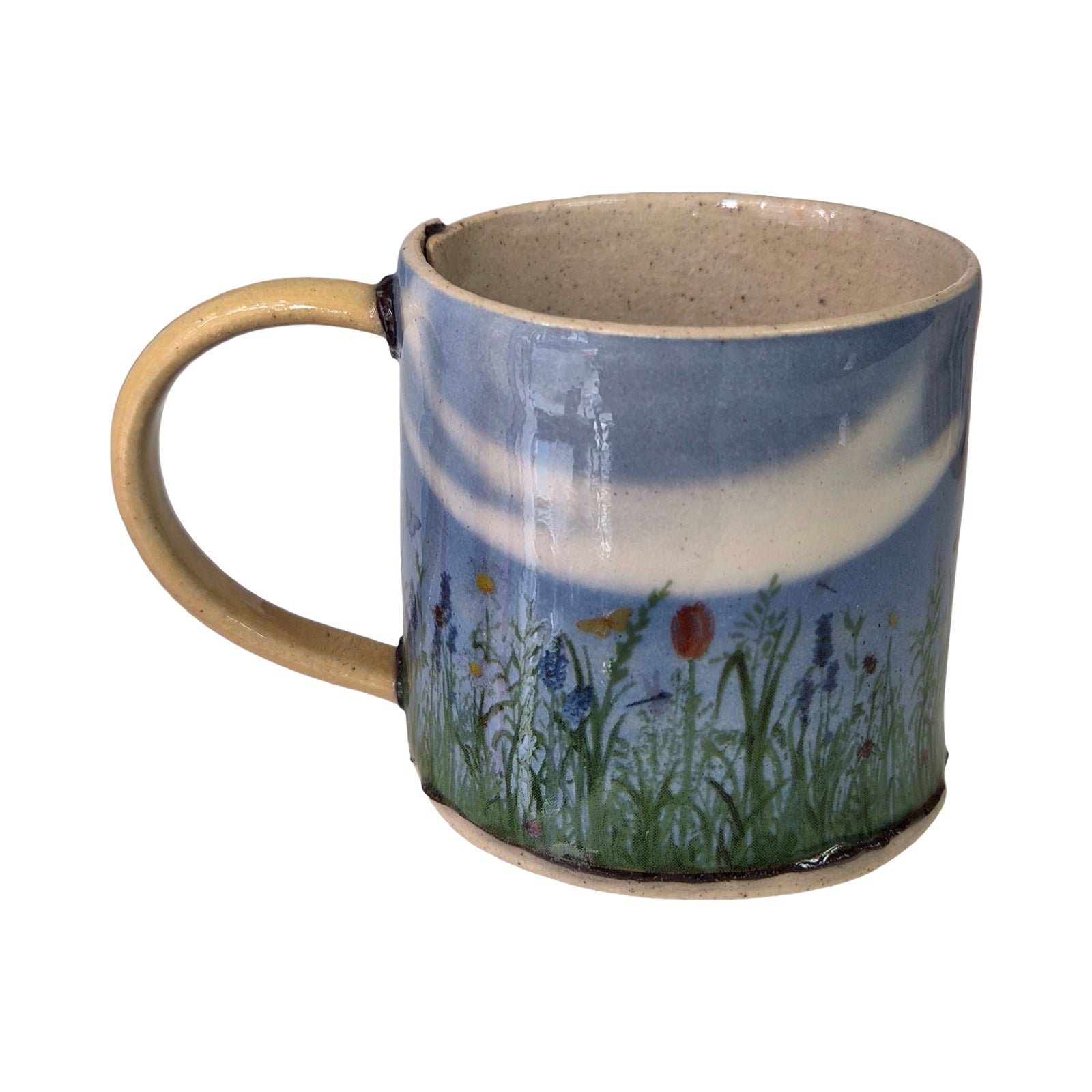 Ceramic mug with nature-themed design on a white background.