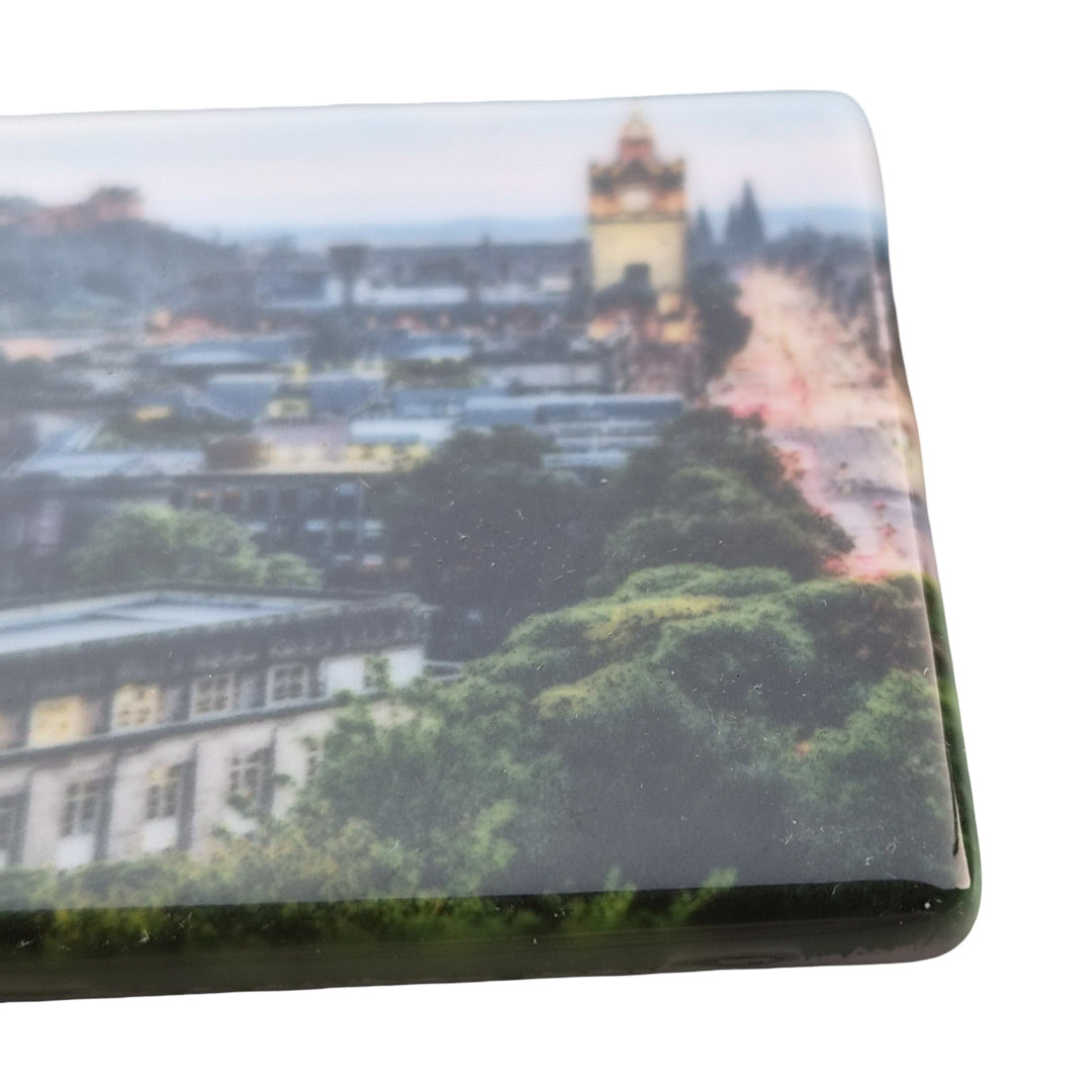 A ceramic magnet with Edinburgh on it.