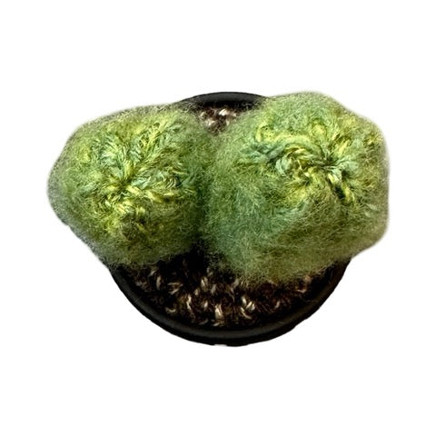 Handmade double crochet cactus in a black and white spotty painted terracotta pot.