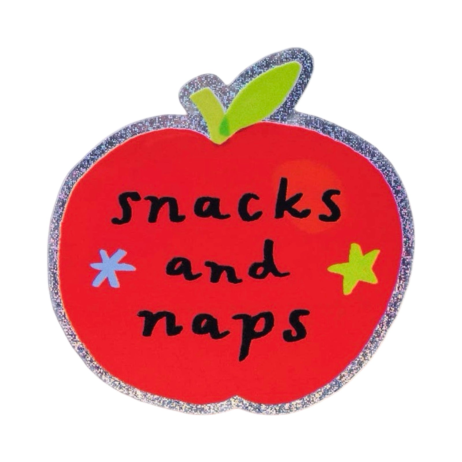 A red apple-shaped sticker with a glittery silver border, a green leaf, and the words 'snacks and naps' in black script, accented with a blue star and a yellow star on a white background.
