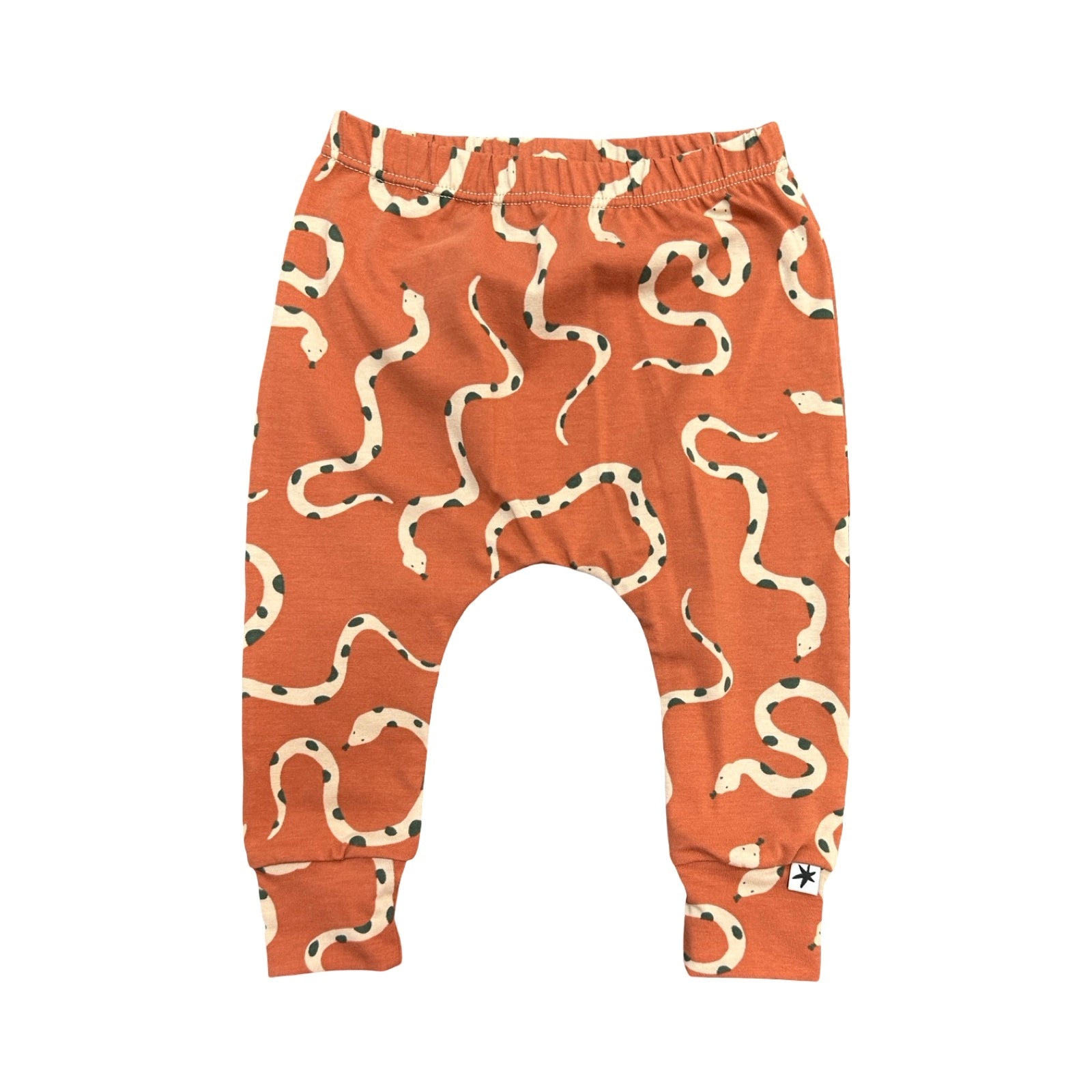 Orange baby leggings with snake pattern on a white background.