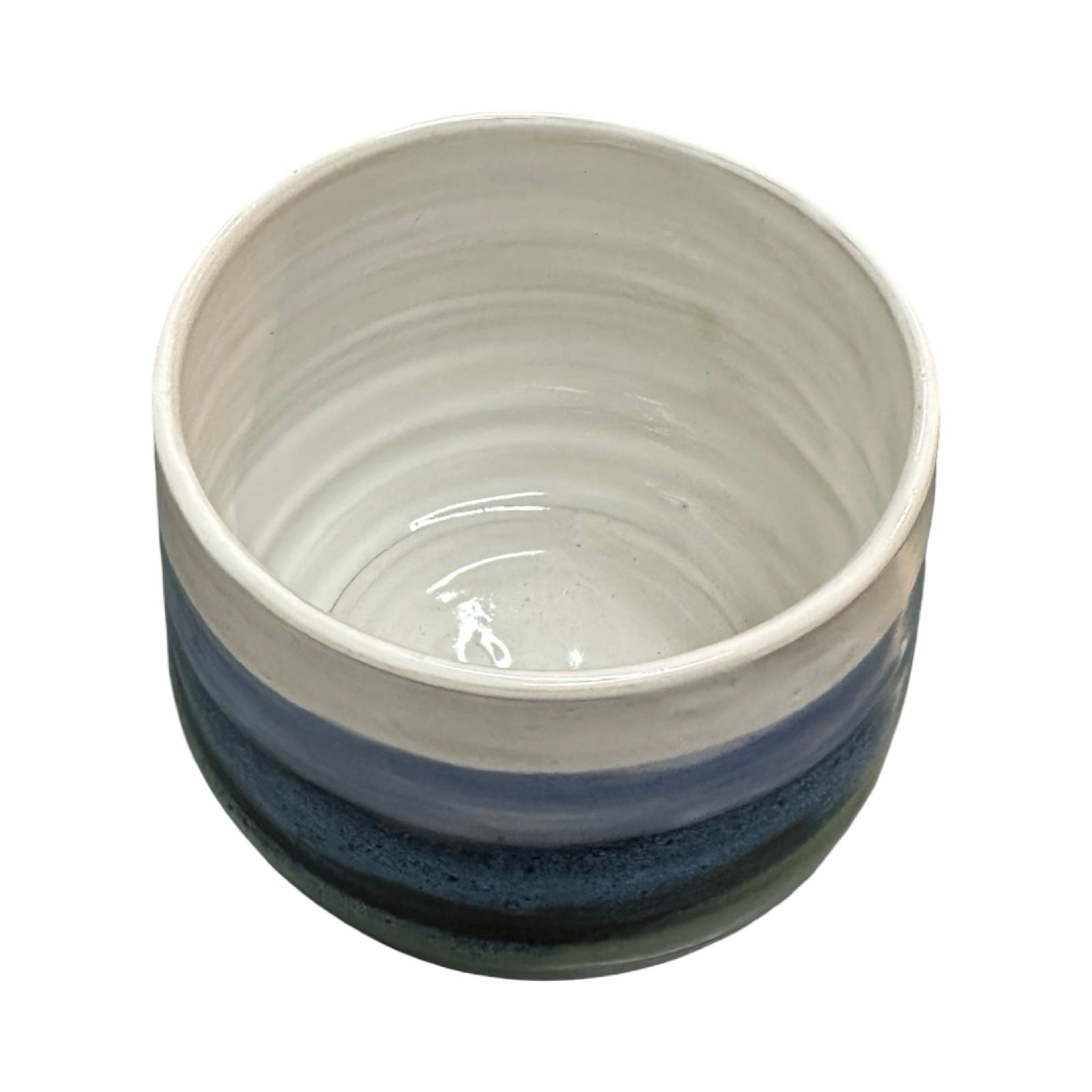Ceramic plant pot with blue and white stripes on a white background.