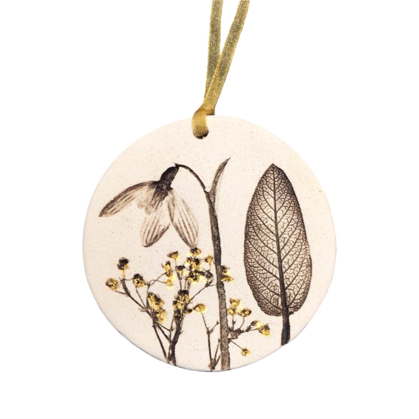 Round ceramic ornament with floral design on a white background