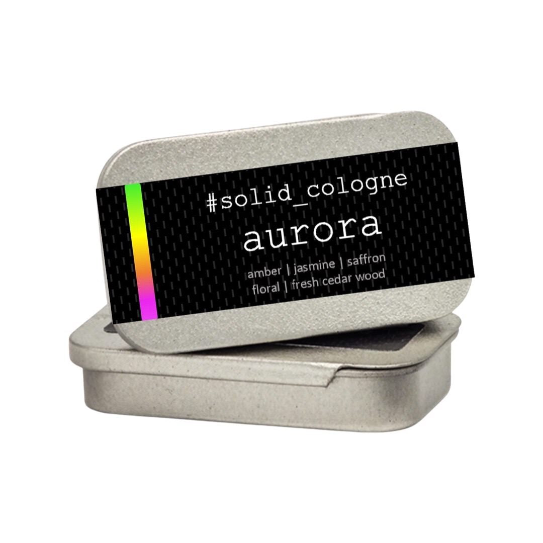 A small silver tin of 'aurora' scented solid cologne.