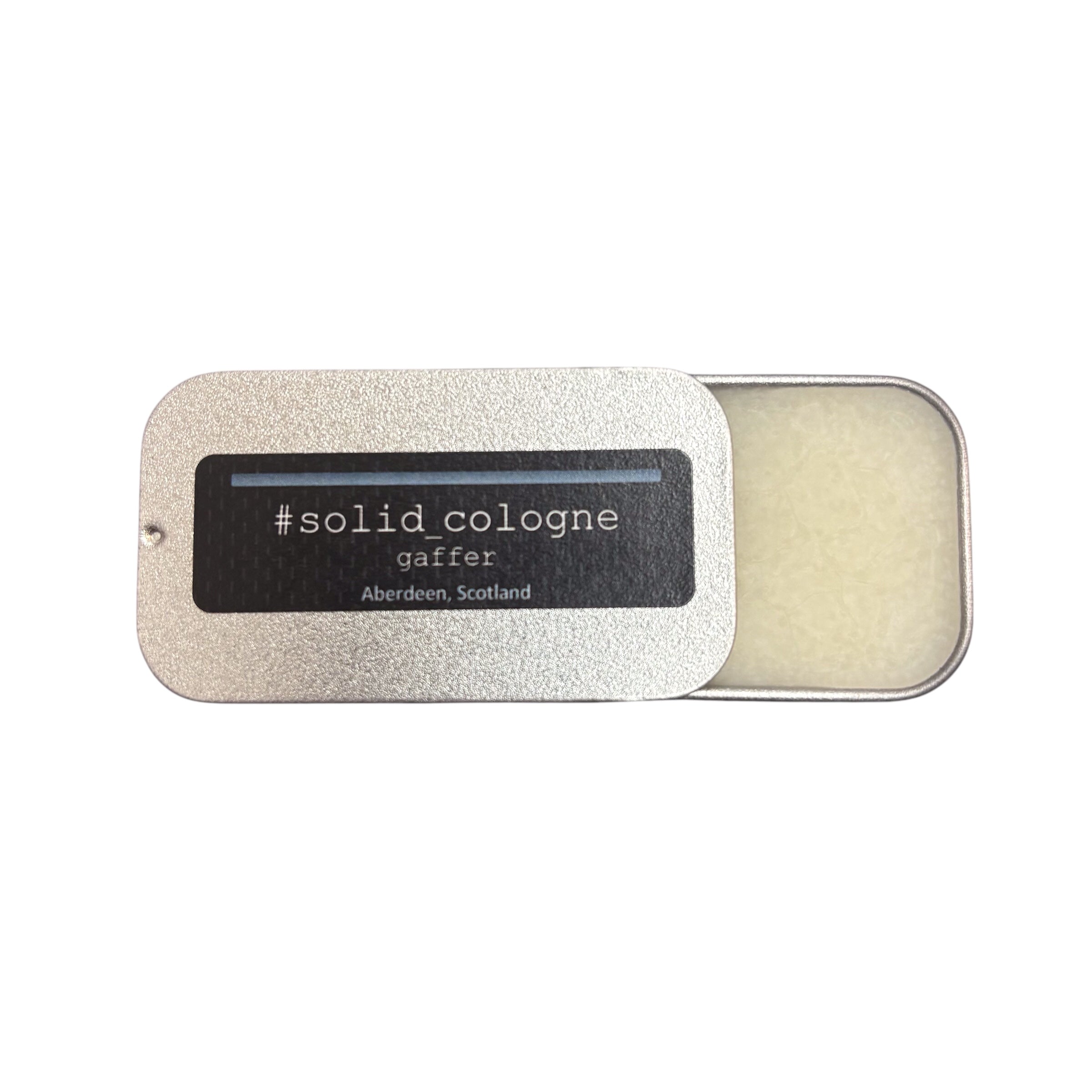 A small silver tin of 'gaffer' scented solid cologne, half open.