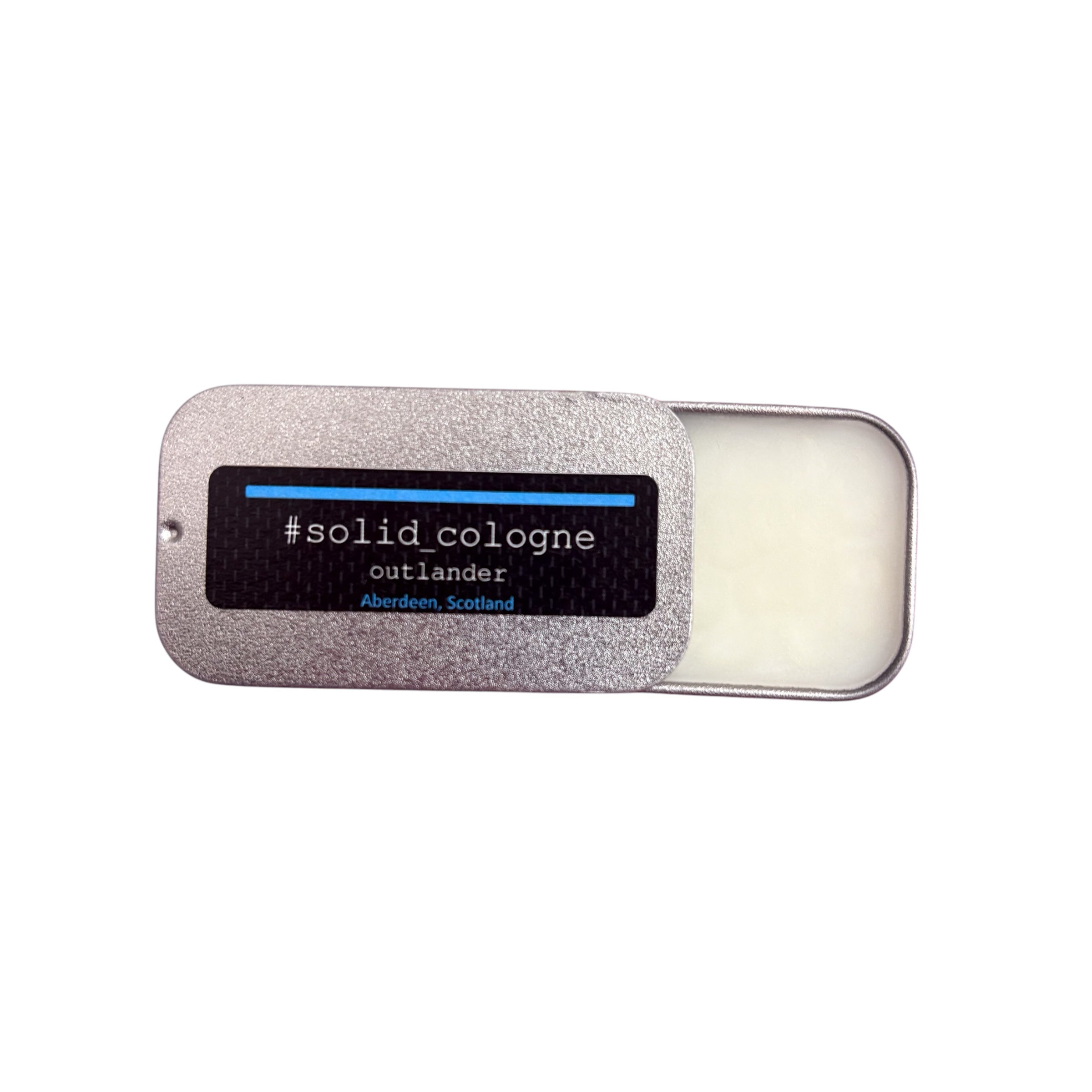 Small silver tin of 'outlander' scented solid cologne, half open.