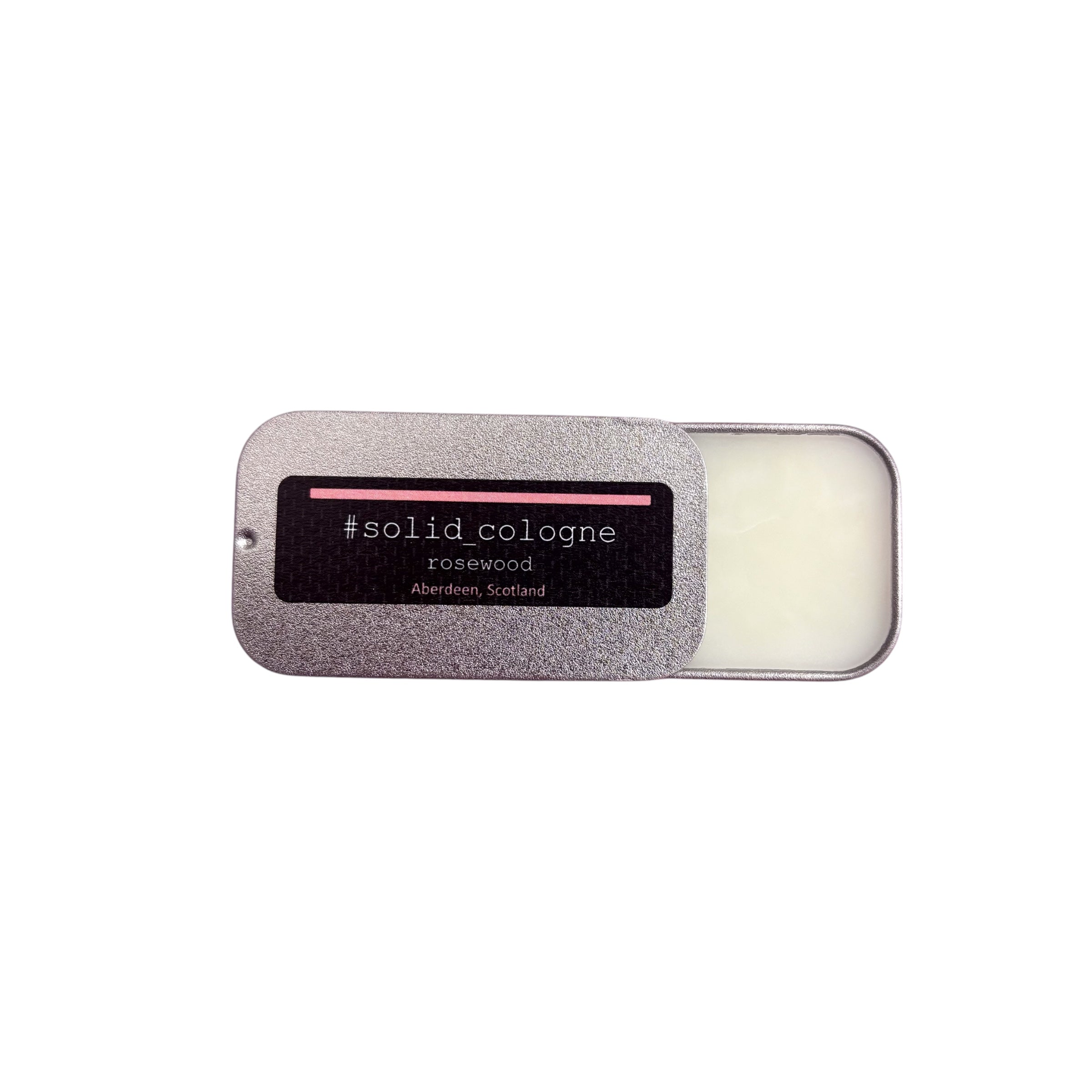 Small silver tin of 'rosewood' scented solid cologne, half open.