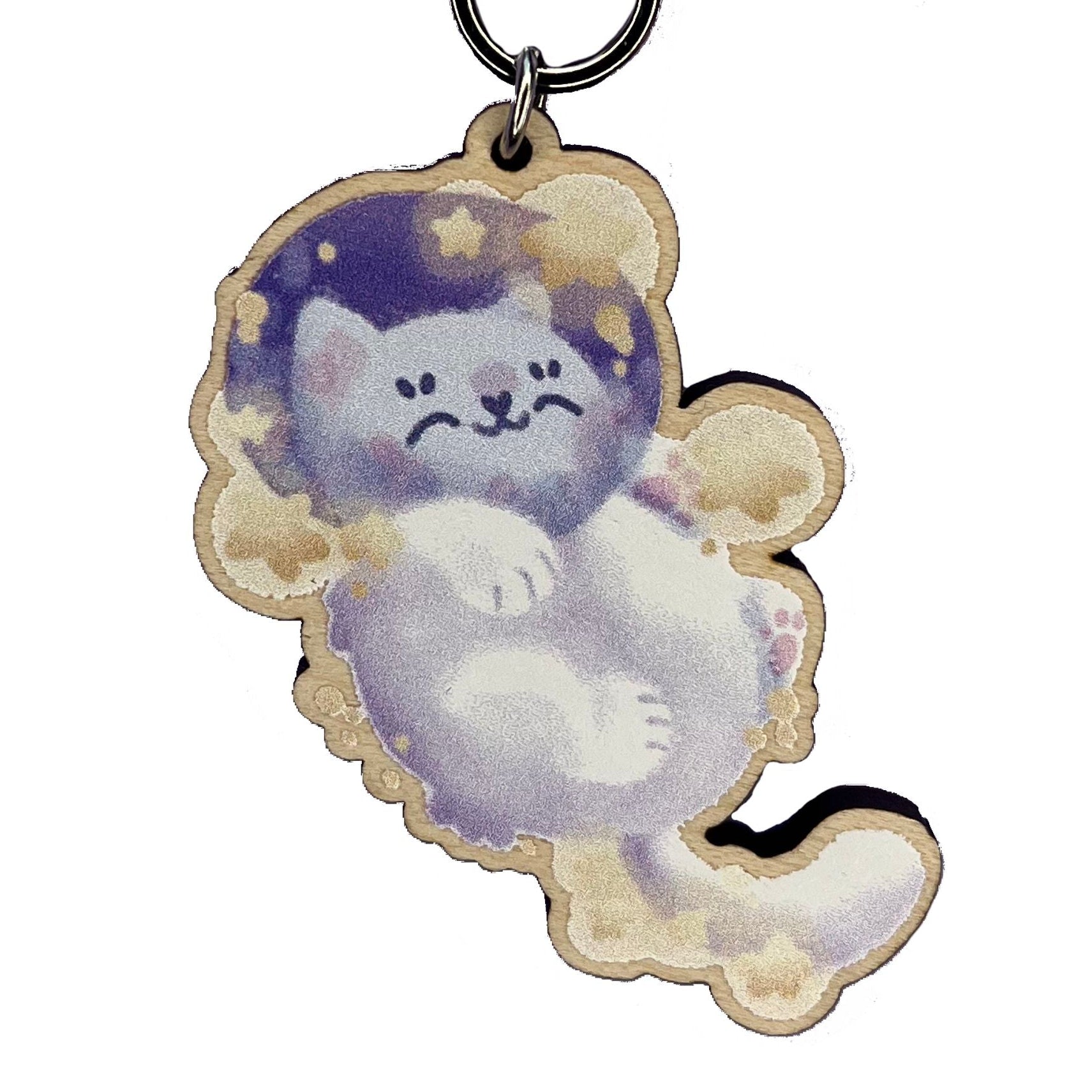 Close up of astronaut cat snoozing amongst yellow stars in a keyring design