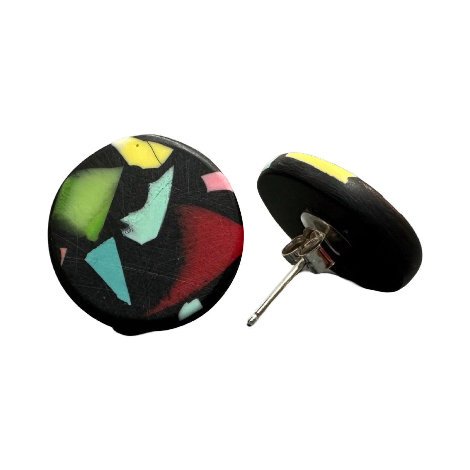 A pair of circular stud earrings with colourful speckles and silver earring posts.