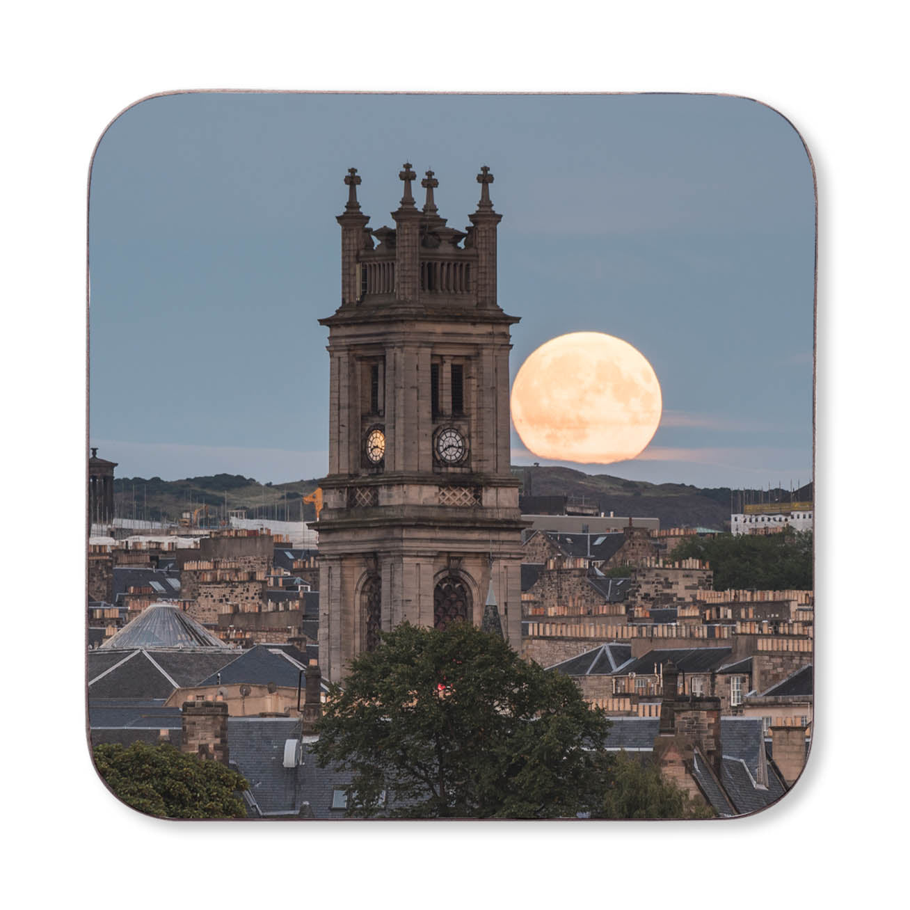 An image of St Stephens Church with the moon rising behind it on a coaster.