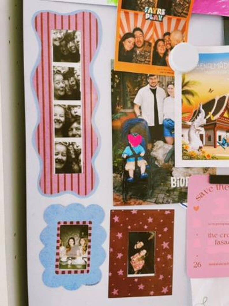 A close-up of a white refrigerator door decorated with scrapbook-style photo frames, magnetic photos, and colourful paper notes.