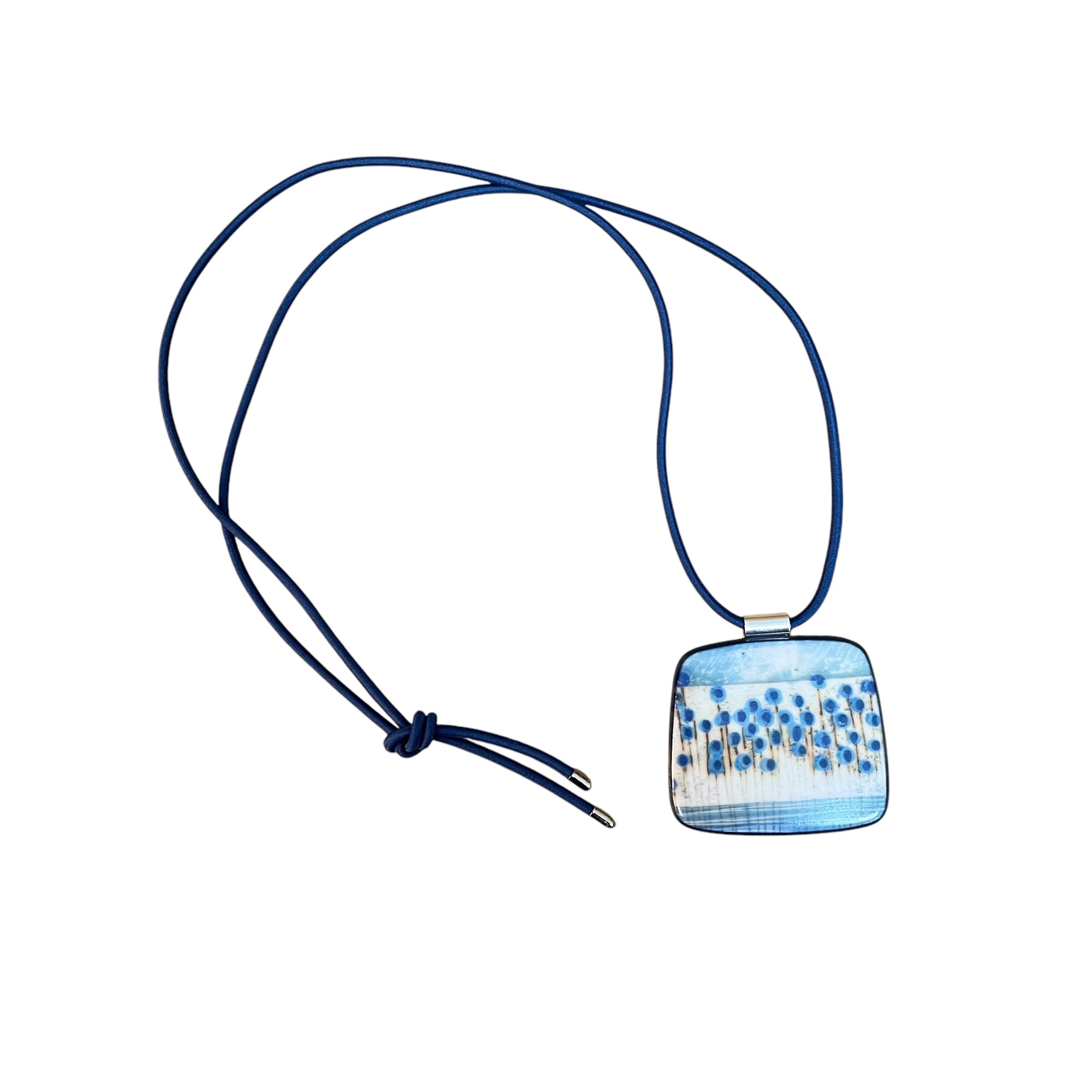 This pendent necklace is made from black porcelain casting slip layered with a white decorating slip and a ceramic decal, it is a wearable piece of art! The brooch features a turquoise, grey, black and cream abstract floral stem pattern, inspired by nature.