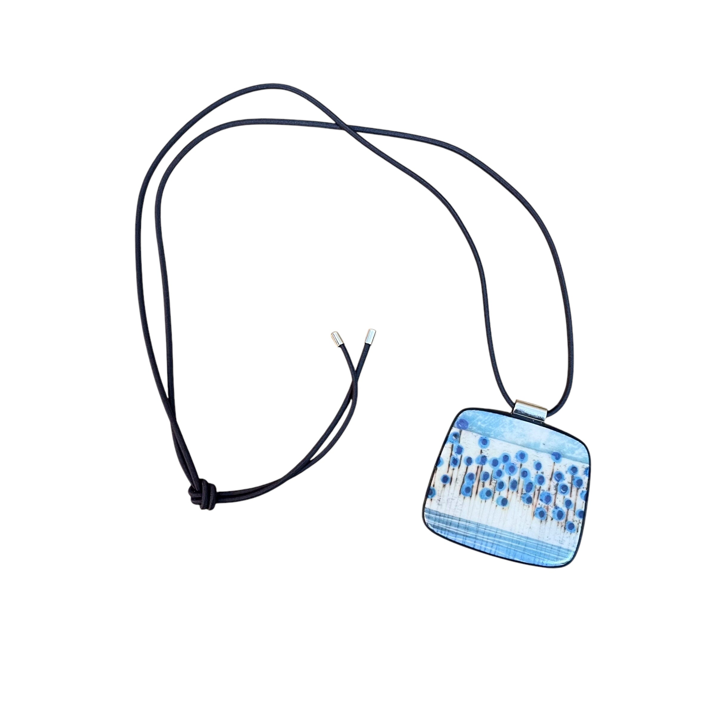 This pendent necklace is made from black porcelain casting slip layered with a white decorating slip and a ceramic decal, it is a wearable piece of art! The brooch features a turquoise, grey, black and cream abstract floral stem pattern, inspired by nature.