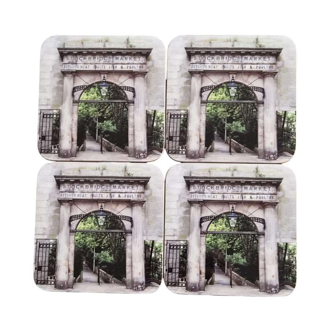 Four coasters with an image of Stockbridge Market archway on a white background