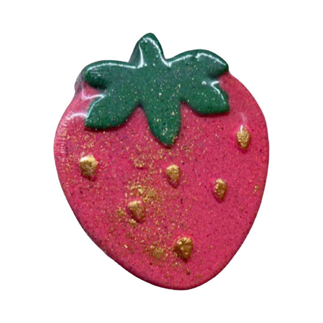 A red strawberry-shaped bath bomb.