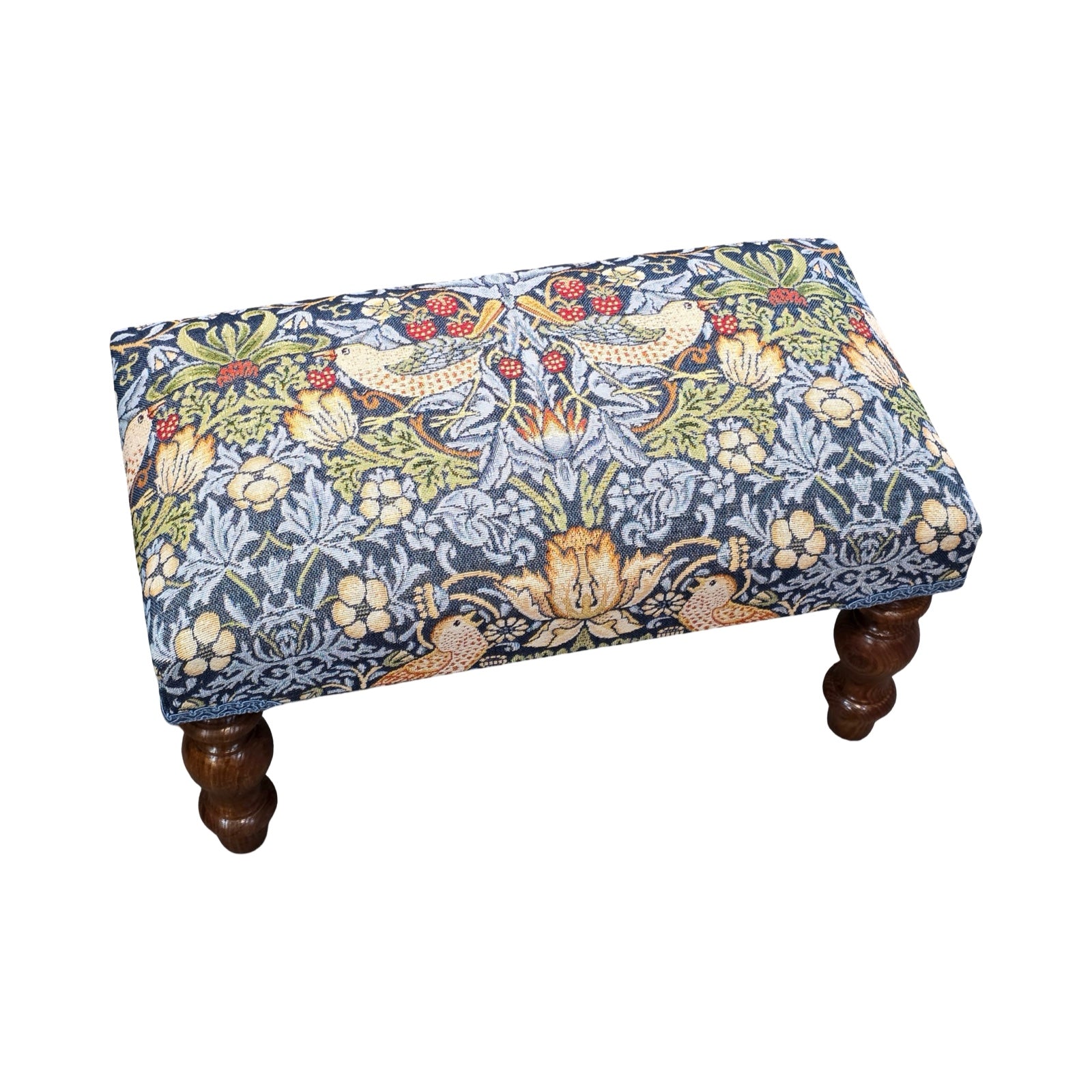 Decorative ottoman with floral pattern on a white background.