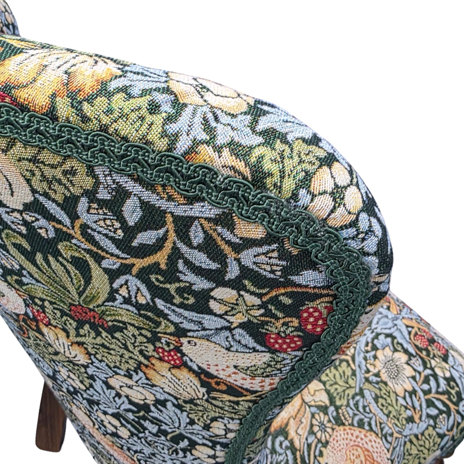 Close-up of a floral-patterned fabric with intricate designs on a white background.