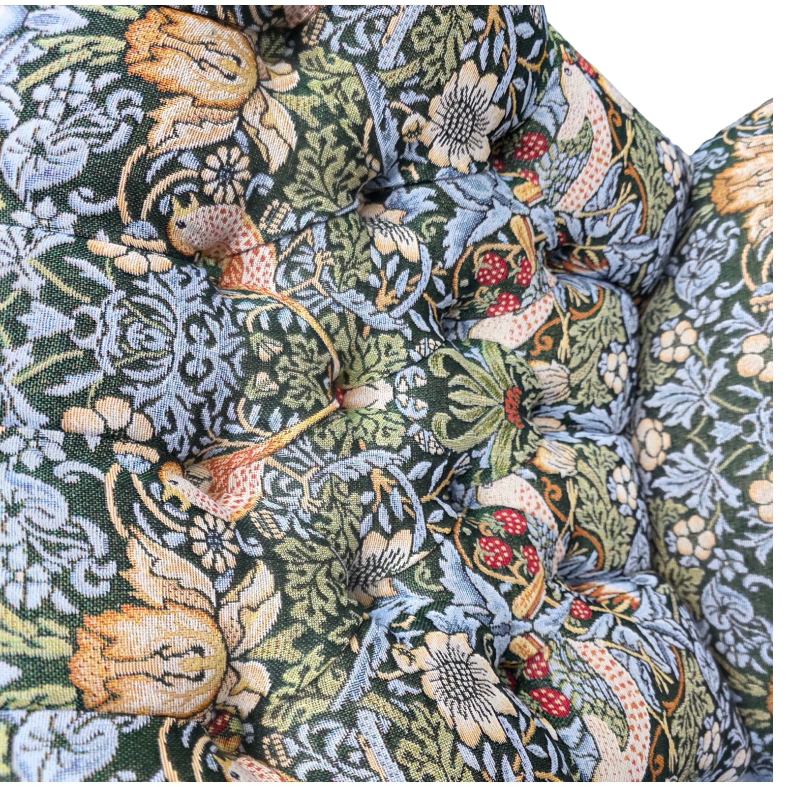 Close-up of a floral and nature-themed fabric pattern with intricate details.