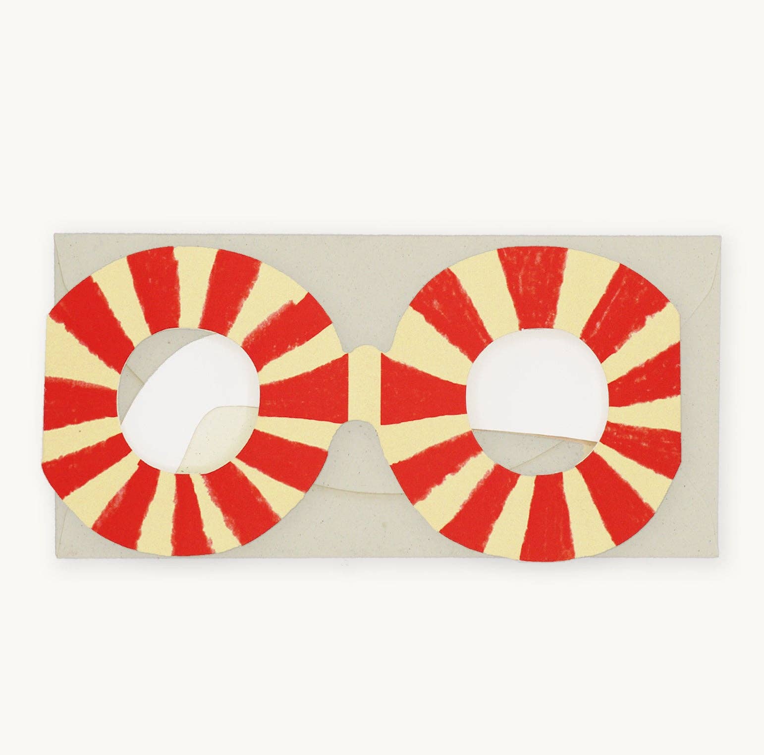 Red and yellow circular sunglasses on a beige background.