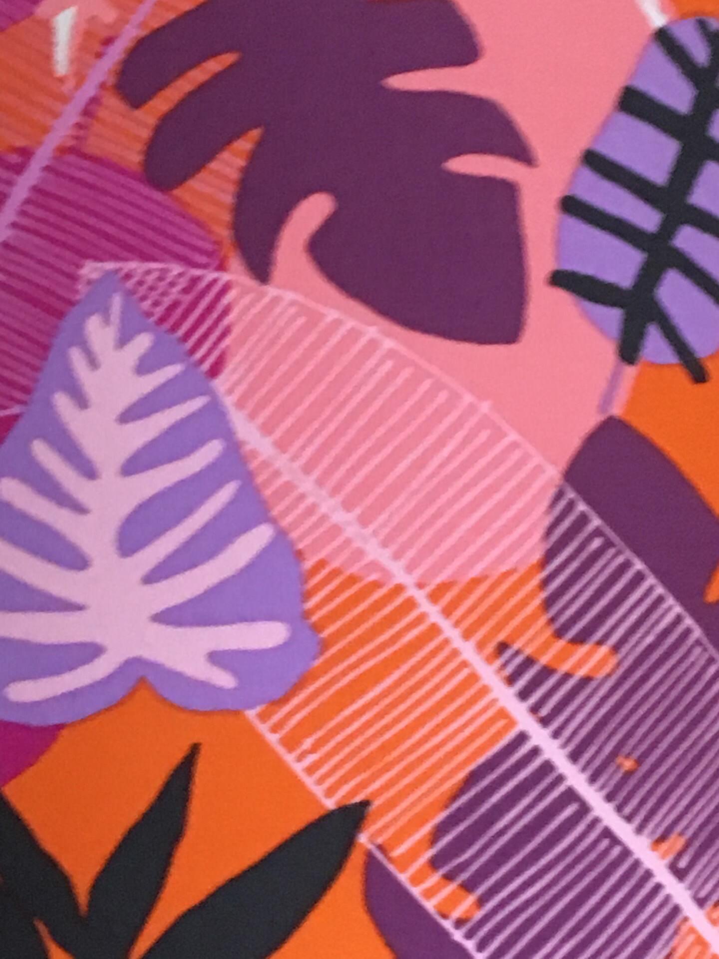 Orange fabric with a variety of pink, white, black and purple leaves.