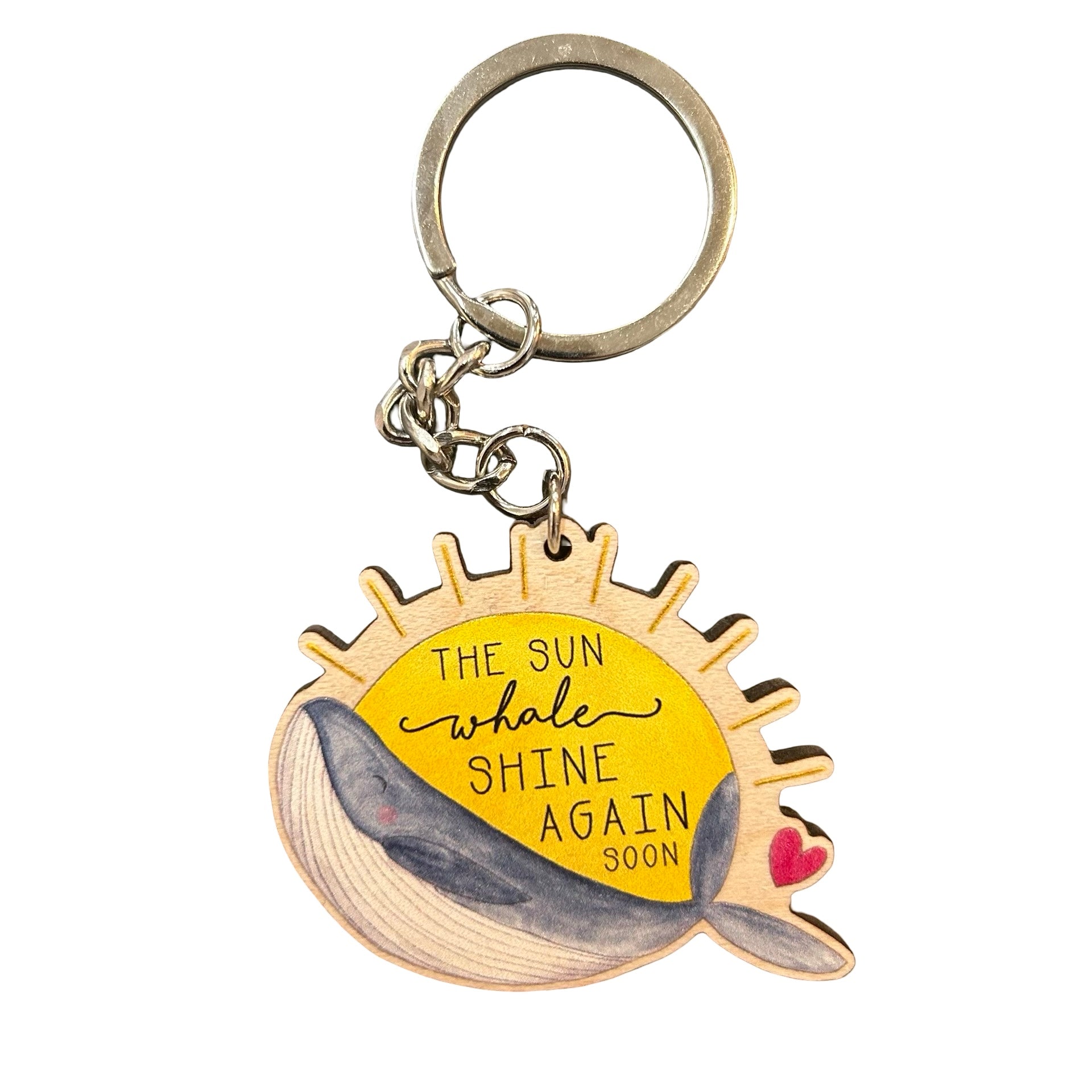 Wooden key ring featuring a whale against a large yellow sun.