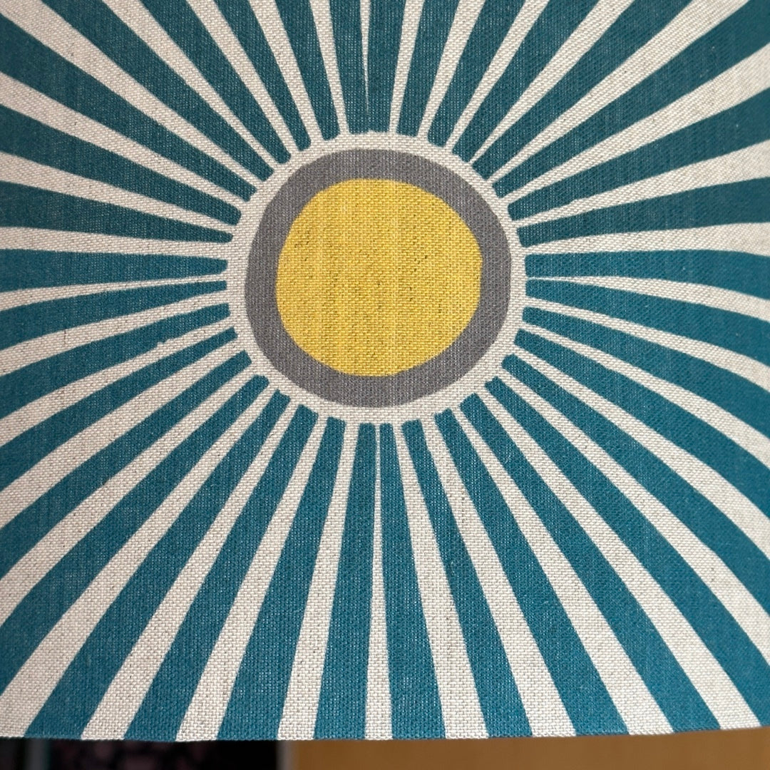 Cream fabric with yellow and grey suns and navy sunbeams