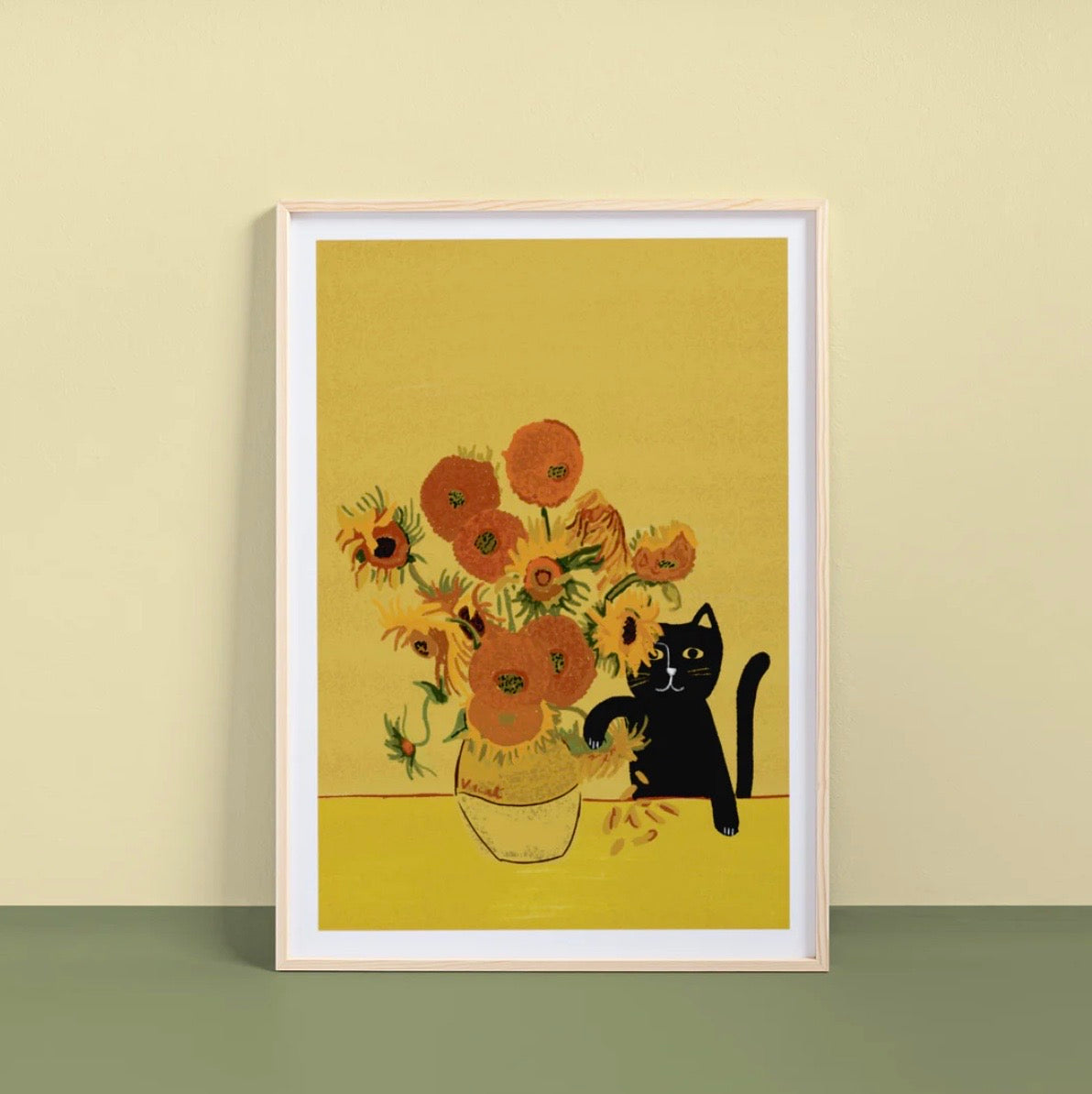 Framed artwork with sunflowers and a black cat on a yellow background.
