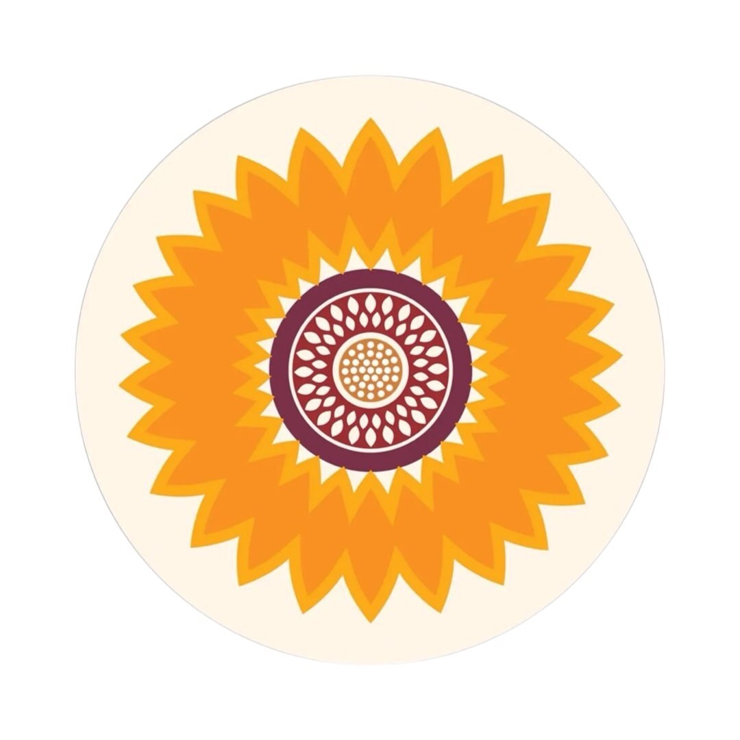 A round placemat with a sunflower abstract design in orange, purple, and white.