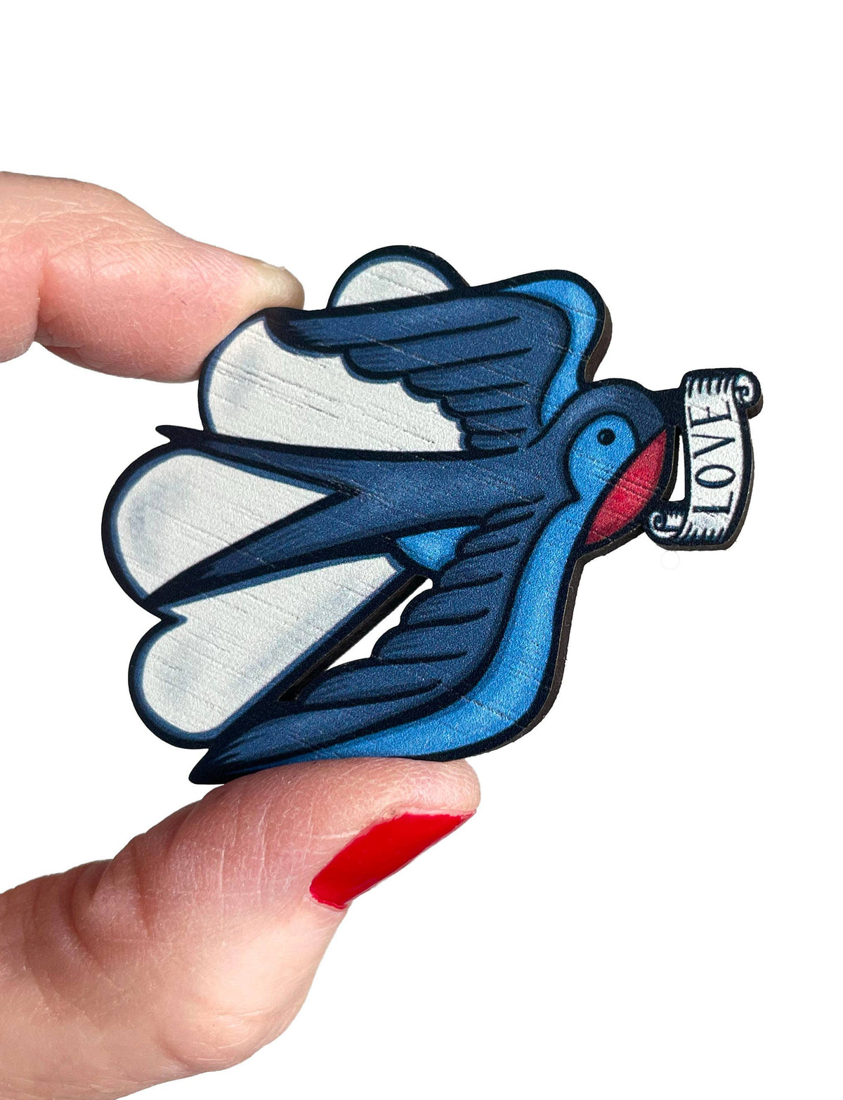 Blue bird-shaped brooch with 'LOVE' on a white background.