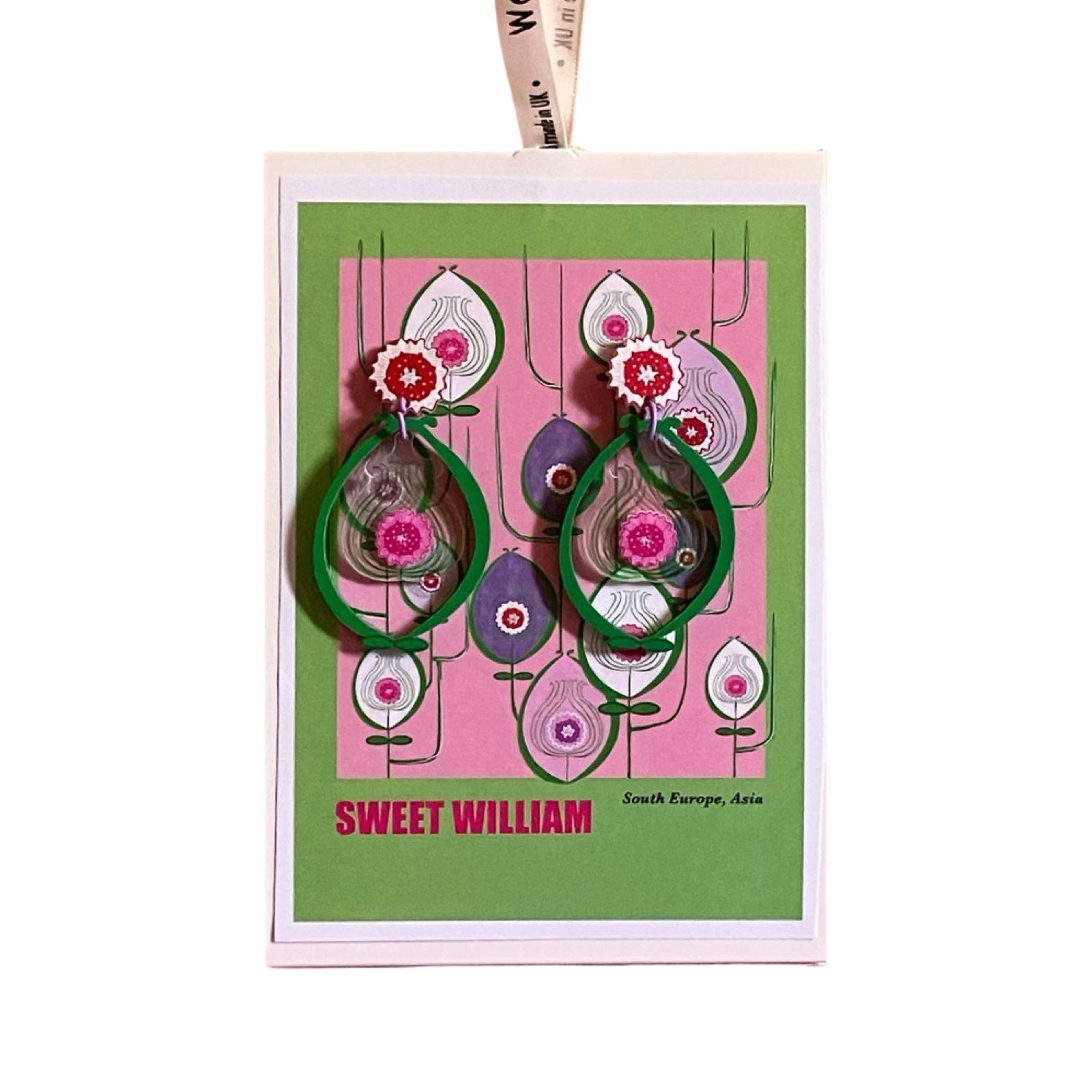 A pair of acrylic earrings with red floral studs and large green ovals with pink flowers inside on backing card.