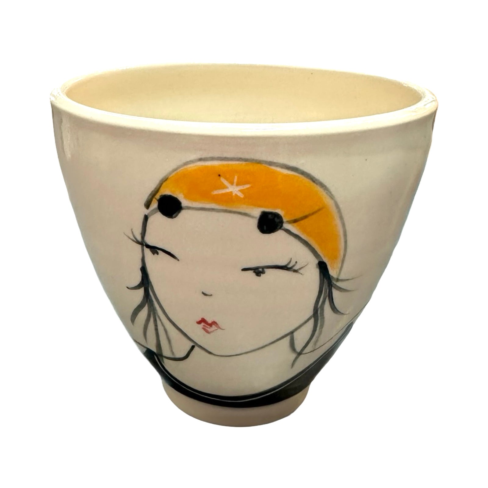 A cream ceramic beaker with a female wild swimmer on the front wearings a black swimsuit and a yellow swim cap.