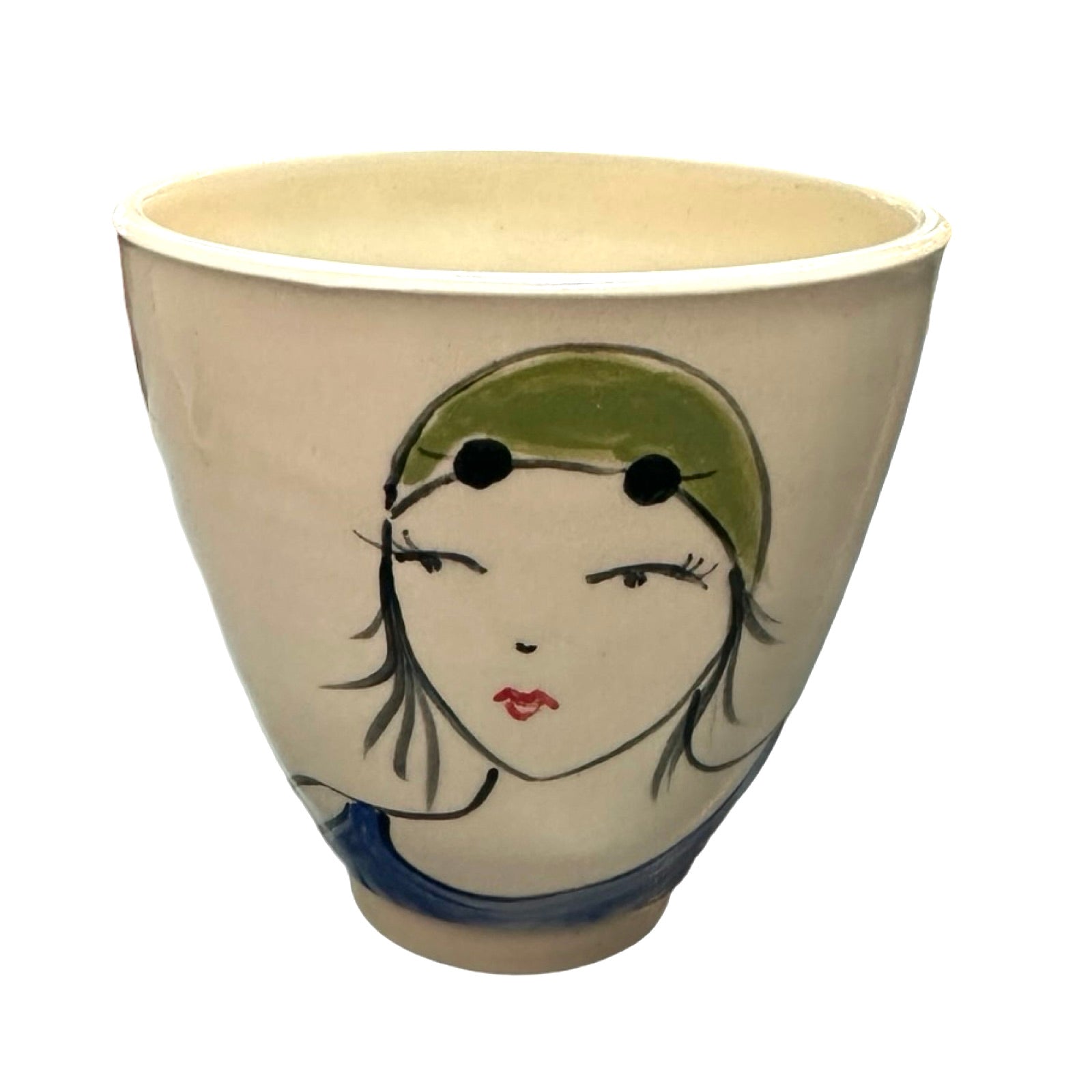 A cream ceramic beaker with a female wild swimmer on the front wearings a blue swimsuit with a green swim cap.