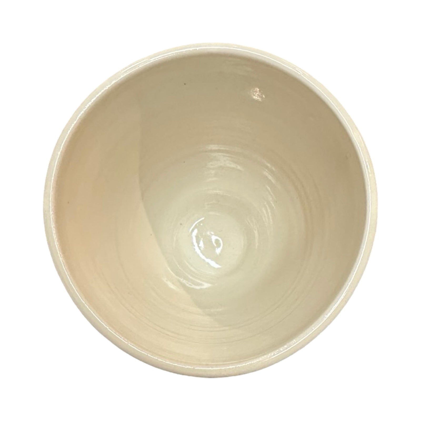 The inside of a cream ceramic beaker.