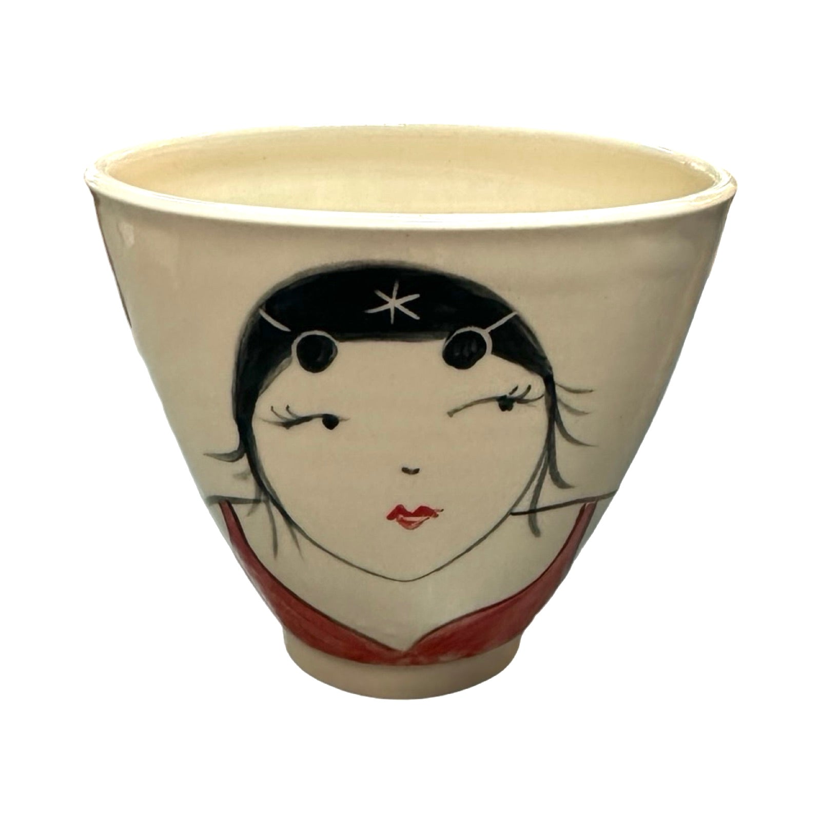 A cream ceramic beaker with a female wild swimmer on the front wearings a red swimsuit and a black swim cap.