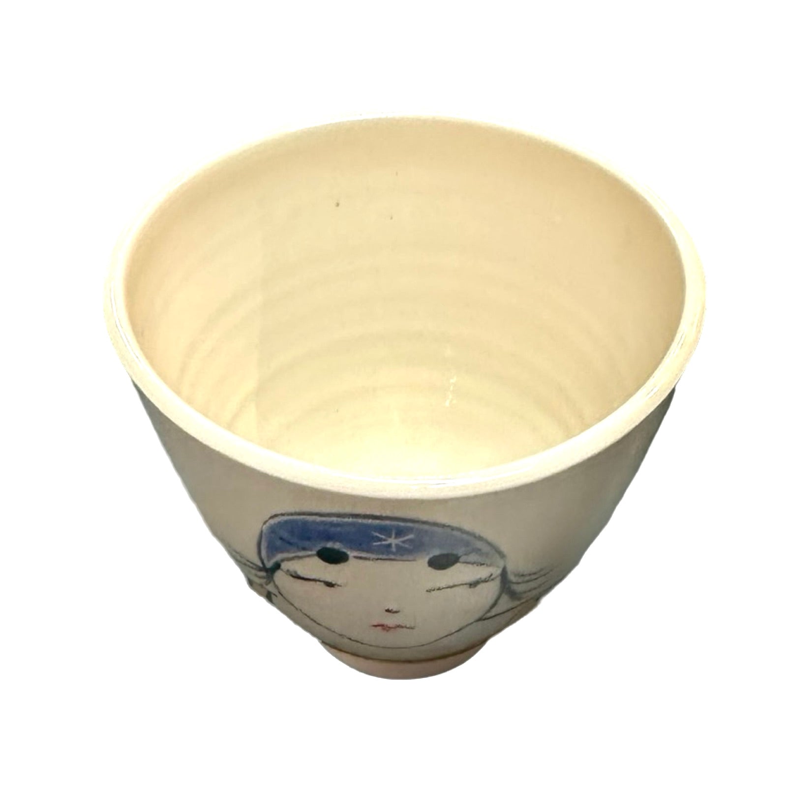 The inside of a cream ceramic beaker.