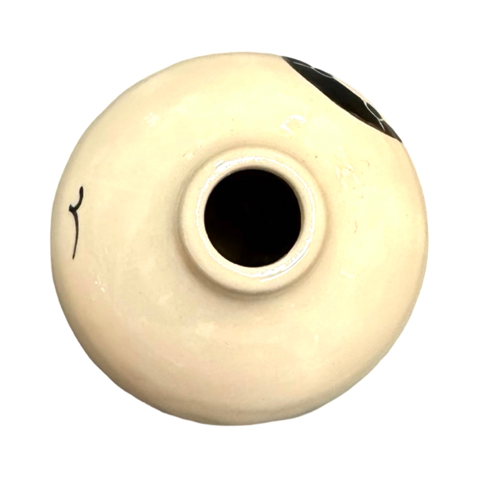 The top of a cream coloured ceramic bud vase.