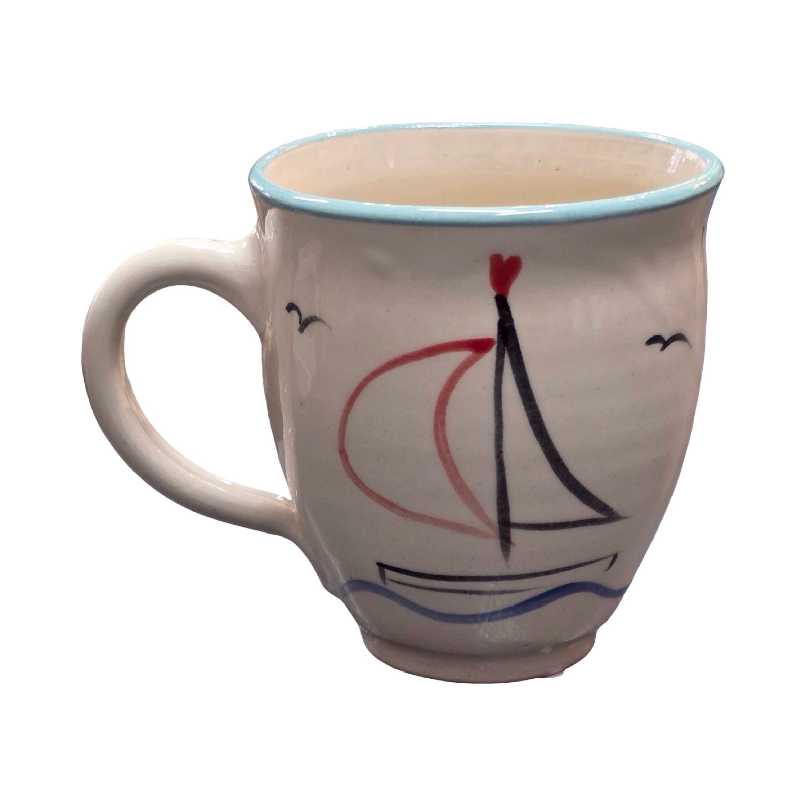 White mug with a sailboat design on a white background.