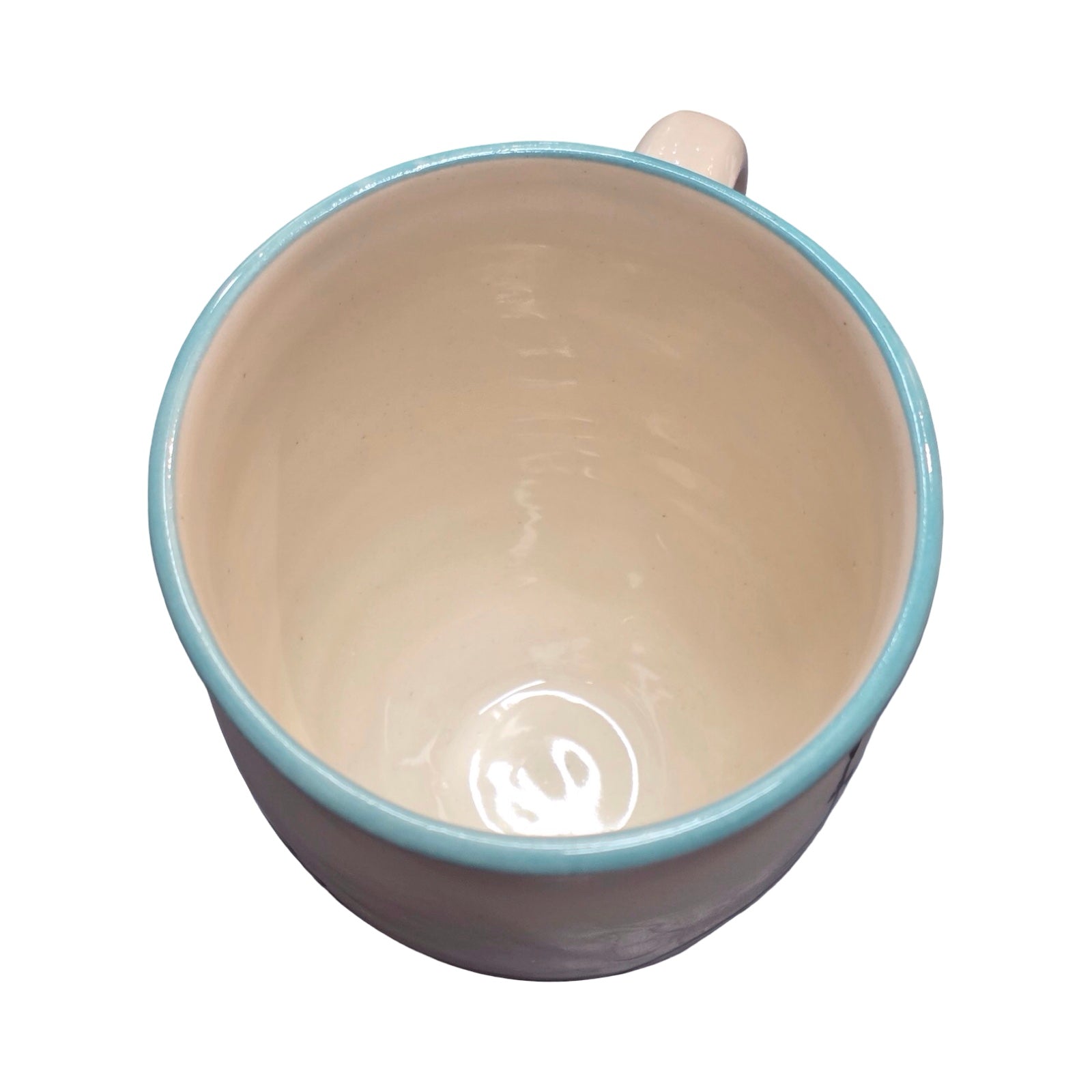 Beige mug with blue rim on a white background.