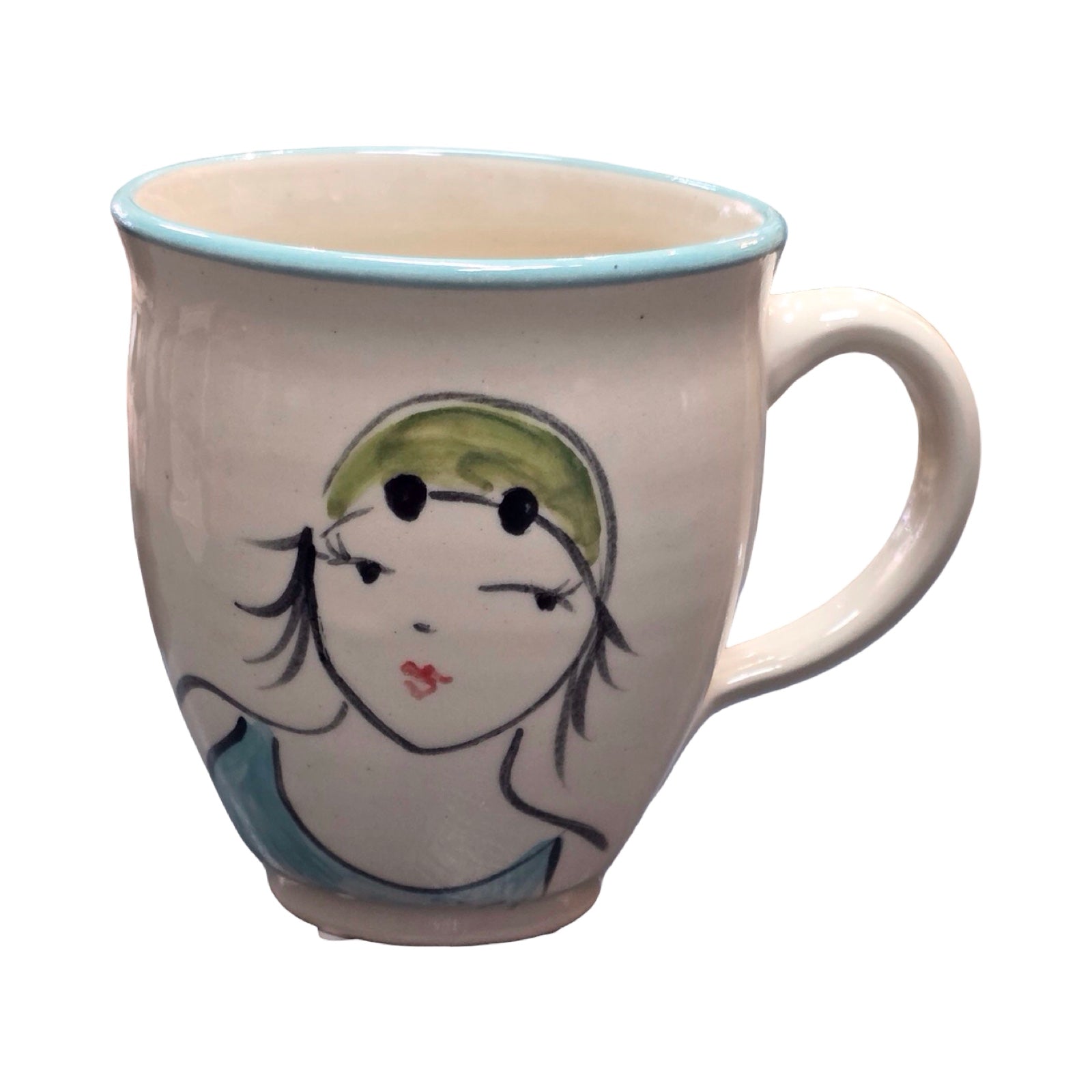 Ceramic mug with a face design on a white background.