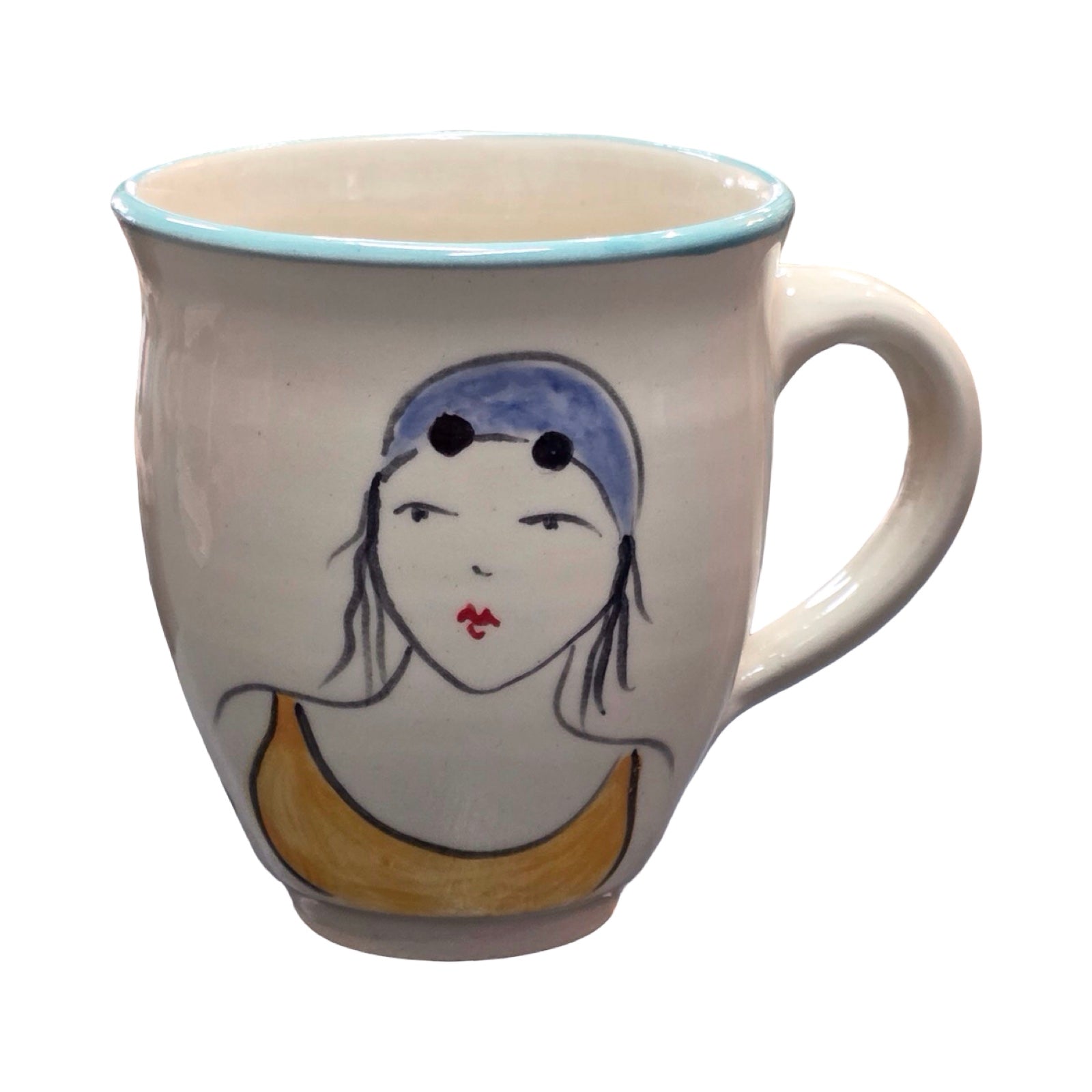Ceramic mug with a face design on a white background.