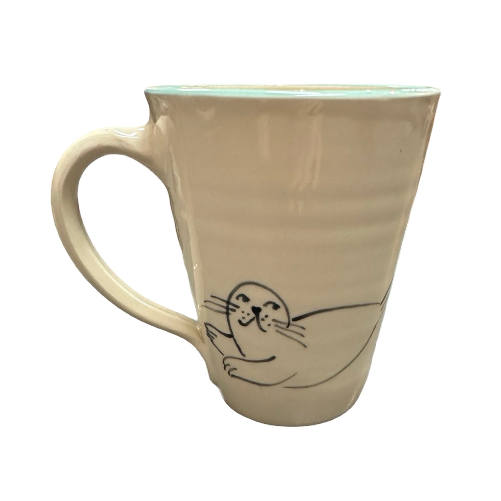 The back of a swimmer mug with a cute seal.