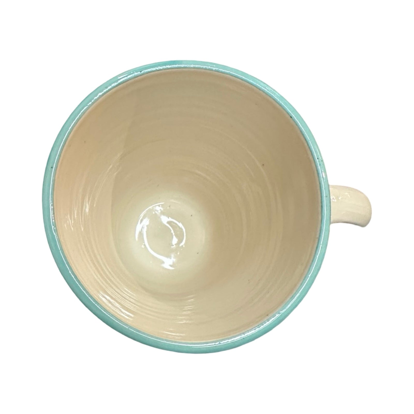 The top of a cream coloured ceramic mug with a turquoise rim.