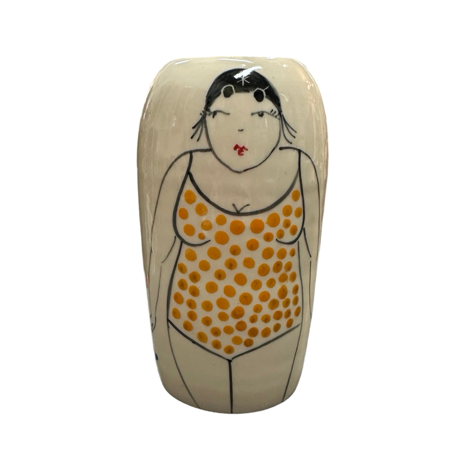 A cylindrical cream ceramic vase with a female wild swimmer on the front wearing a yellow polka dot swimsuit and a black swim cap.