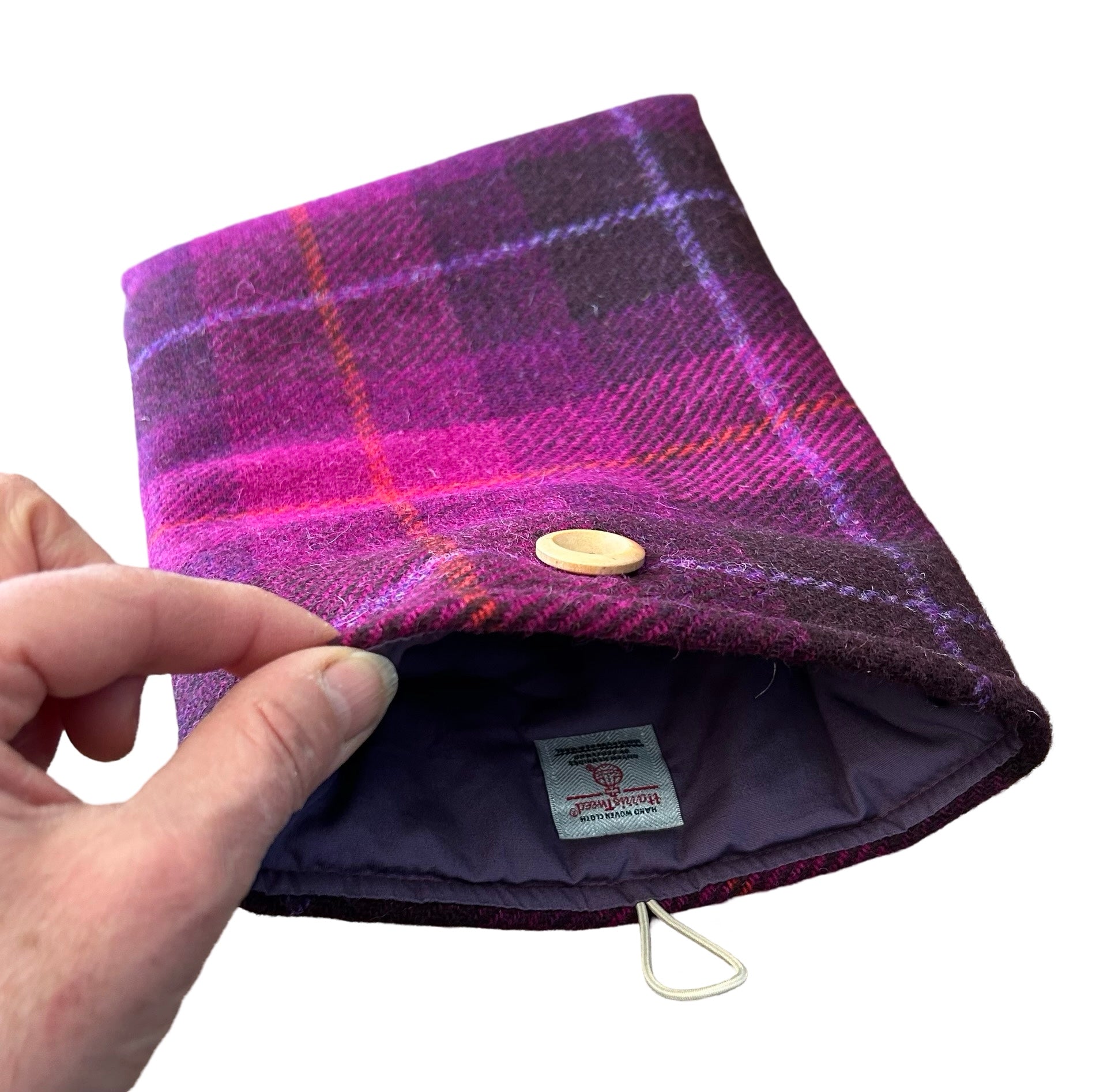 Showing the inner purple cotton lining of the tablet sleeve.  The inner has a Harris tweed Orb label sewn into it.