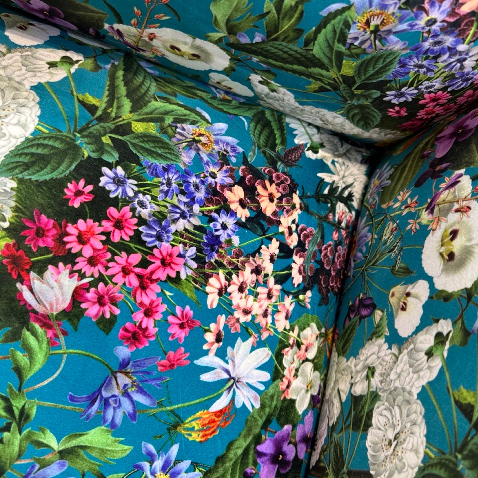 Close-up of a floral pattern with colorful flowers on a blue background.