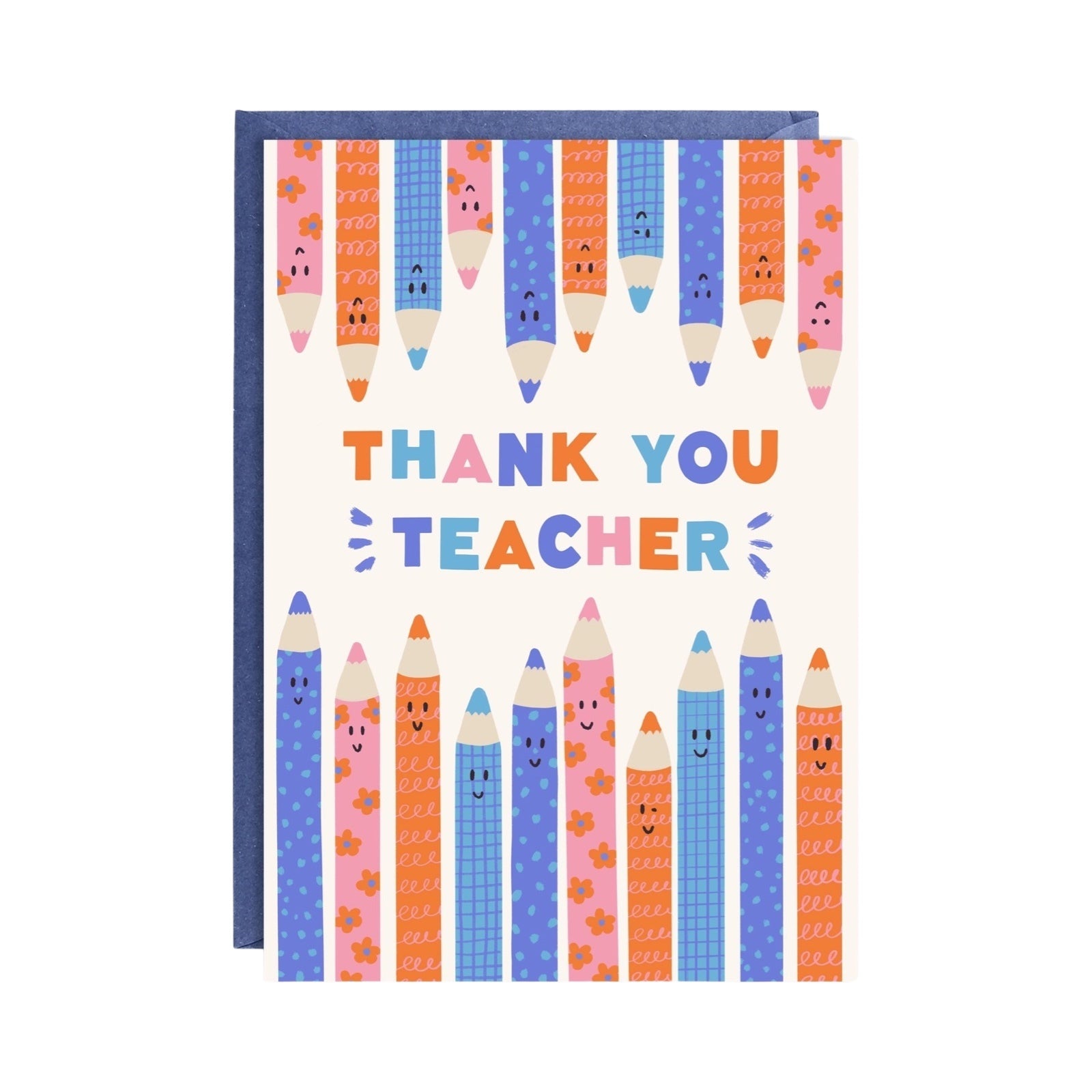 A greeting card with a colorful pencil illustration along the top and bottom, and the text 'Thank You Teacher' in the center. The card is presented with a blue background and a recycled brown Kraft envelope.