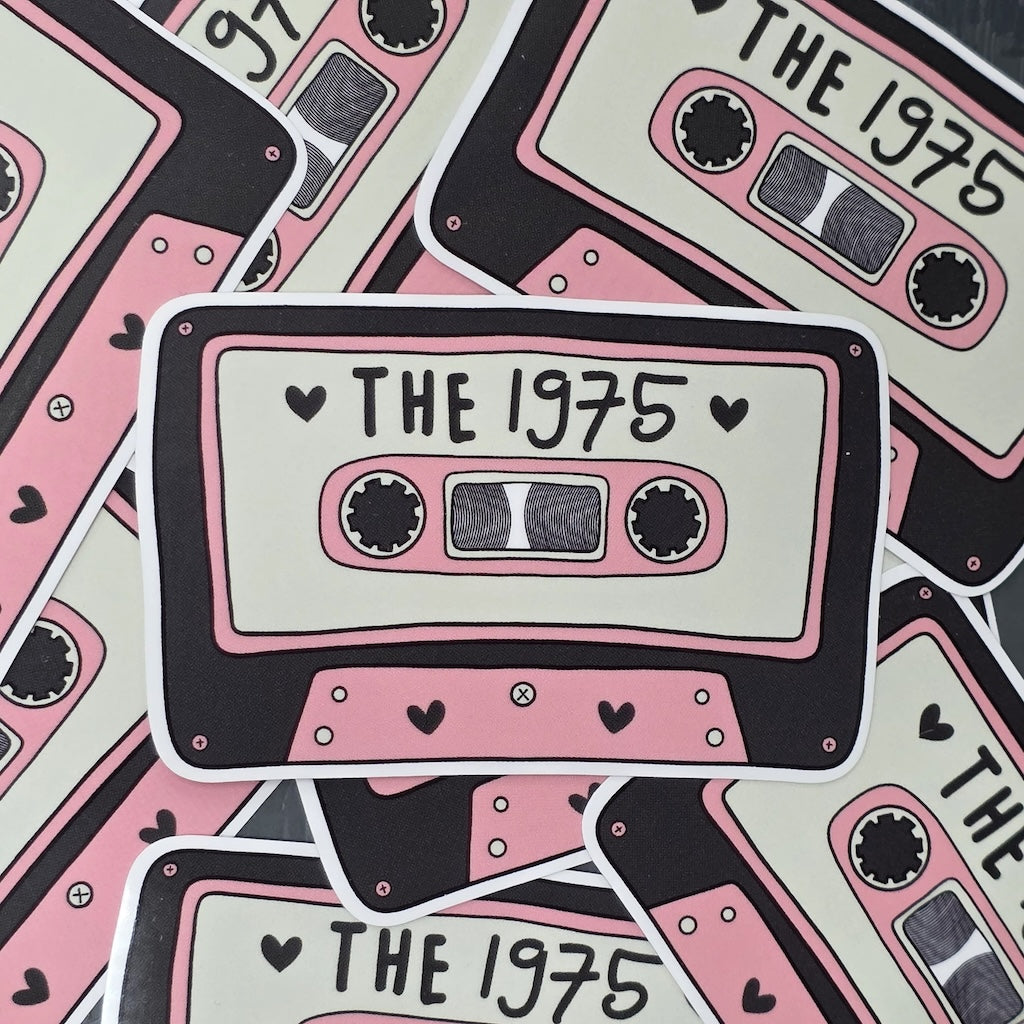 Stickers with 'The 1975' design on a pink and black cassette tape pattern.