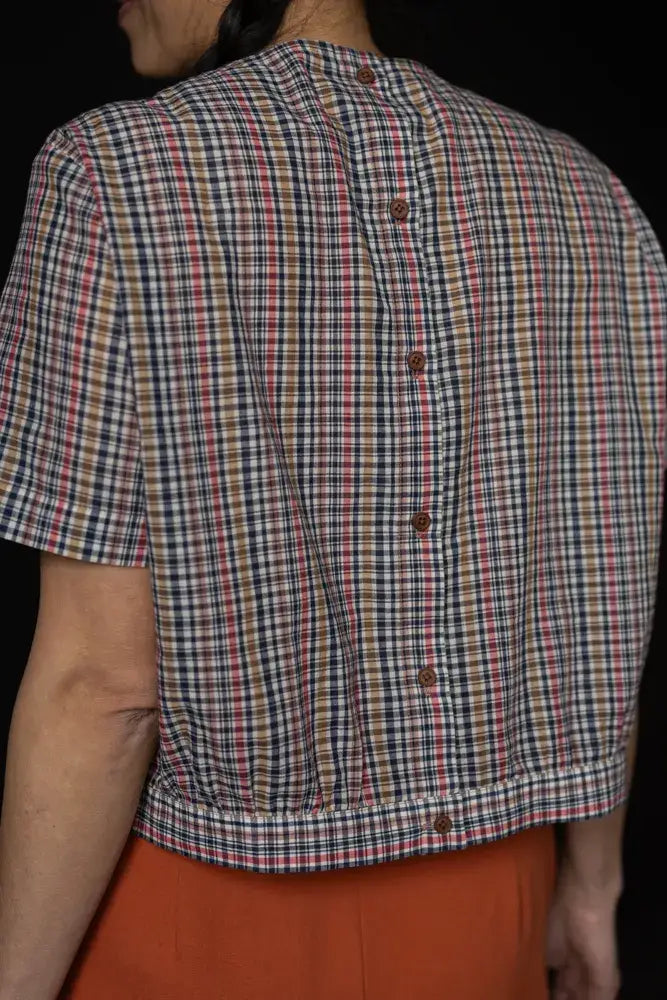 Sewing pattern for a feminine blouse, with back buttons, that gently gathers into a waistband.